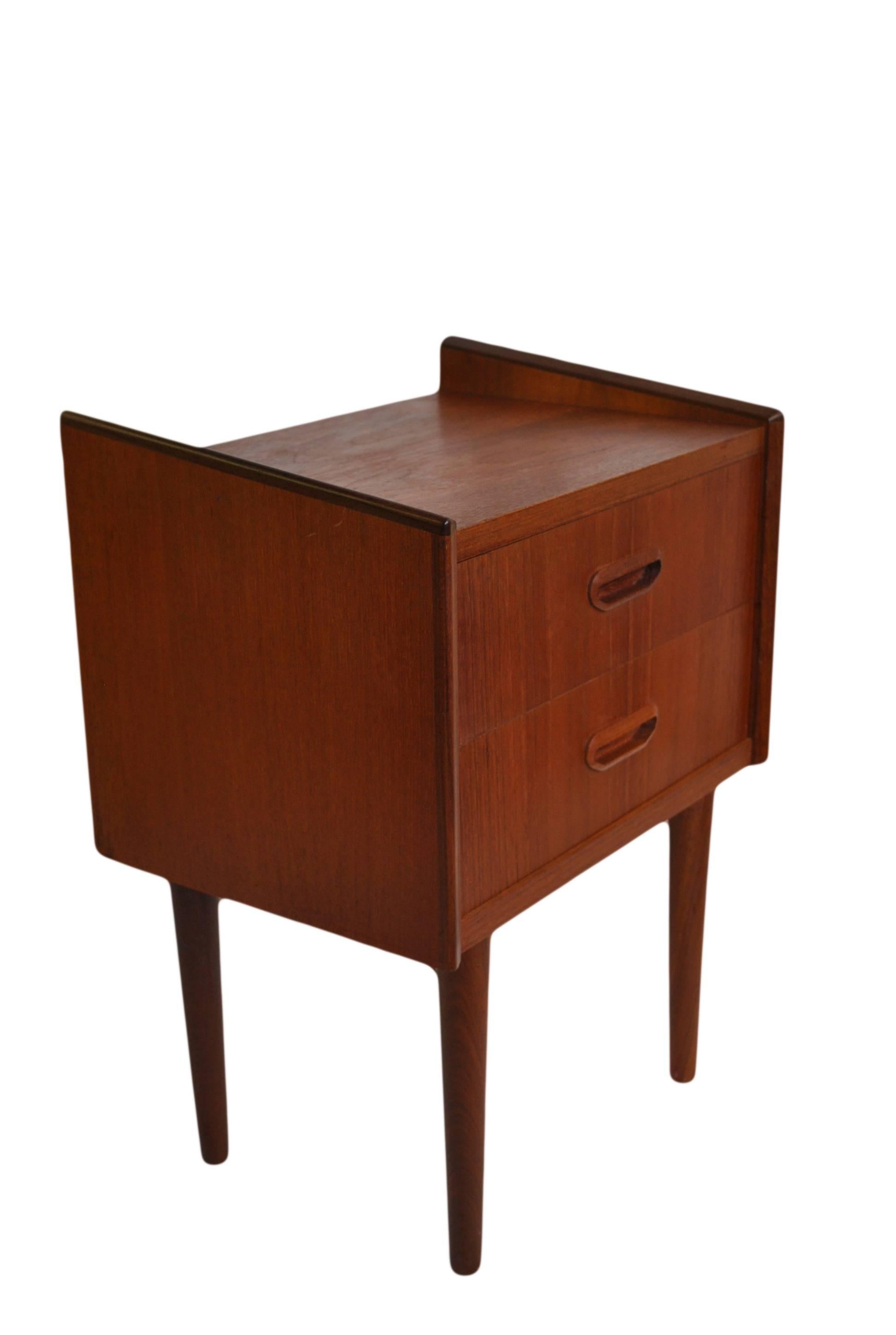 Matching pair of teak bedside two-drawer nightstands, Denmark, circa 1960.
Simple Danish angled design.