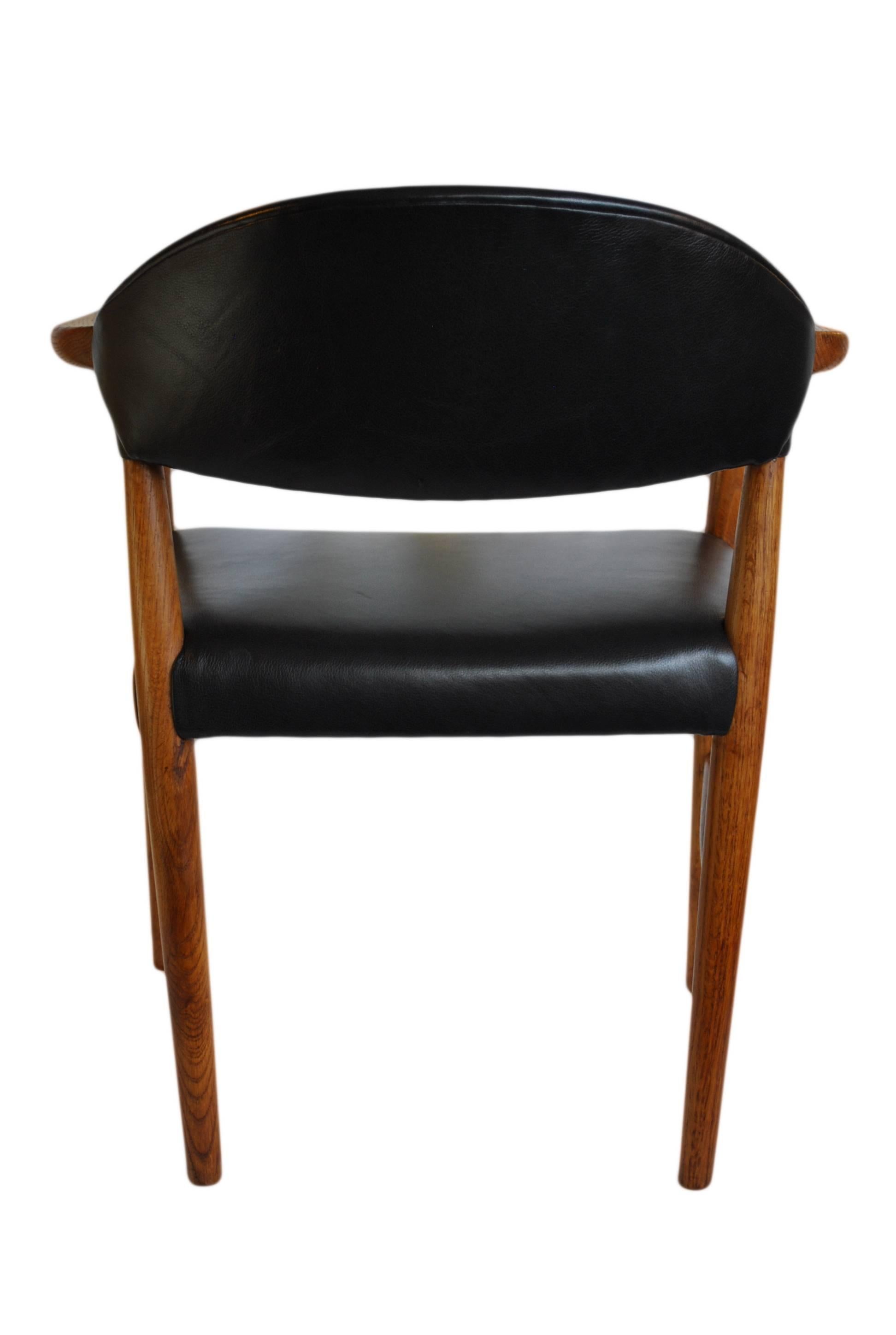 Danish Kurt Olsen chair, fully reupholstered in black leather.