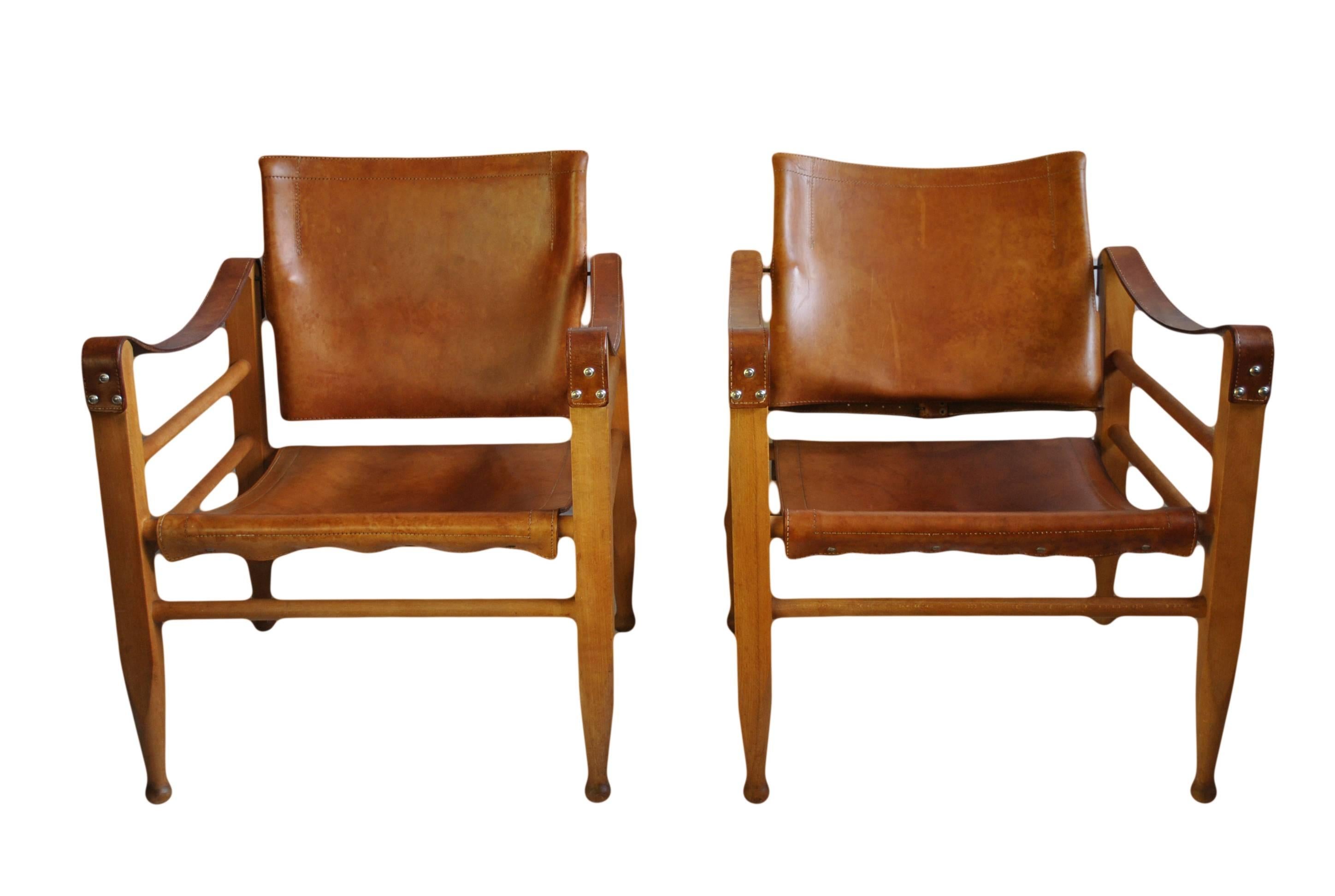 Wonderful matching pair of rare Børge Mogensen model 2221 safari chairs. Manufactured in Denmark during the 1950s.
Lovely aged cognac saddle leather on a beech frame with pivoting back rests.

Worldwide shipping available.