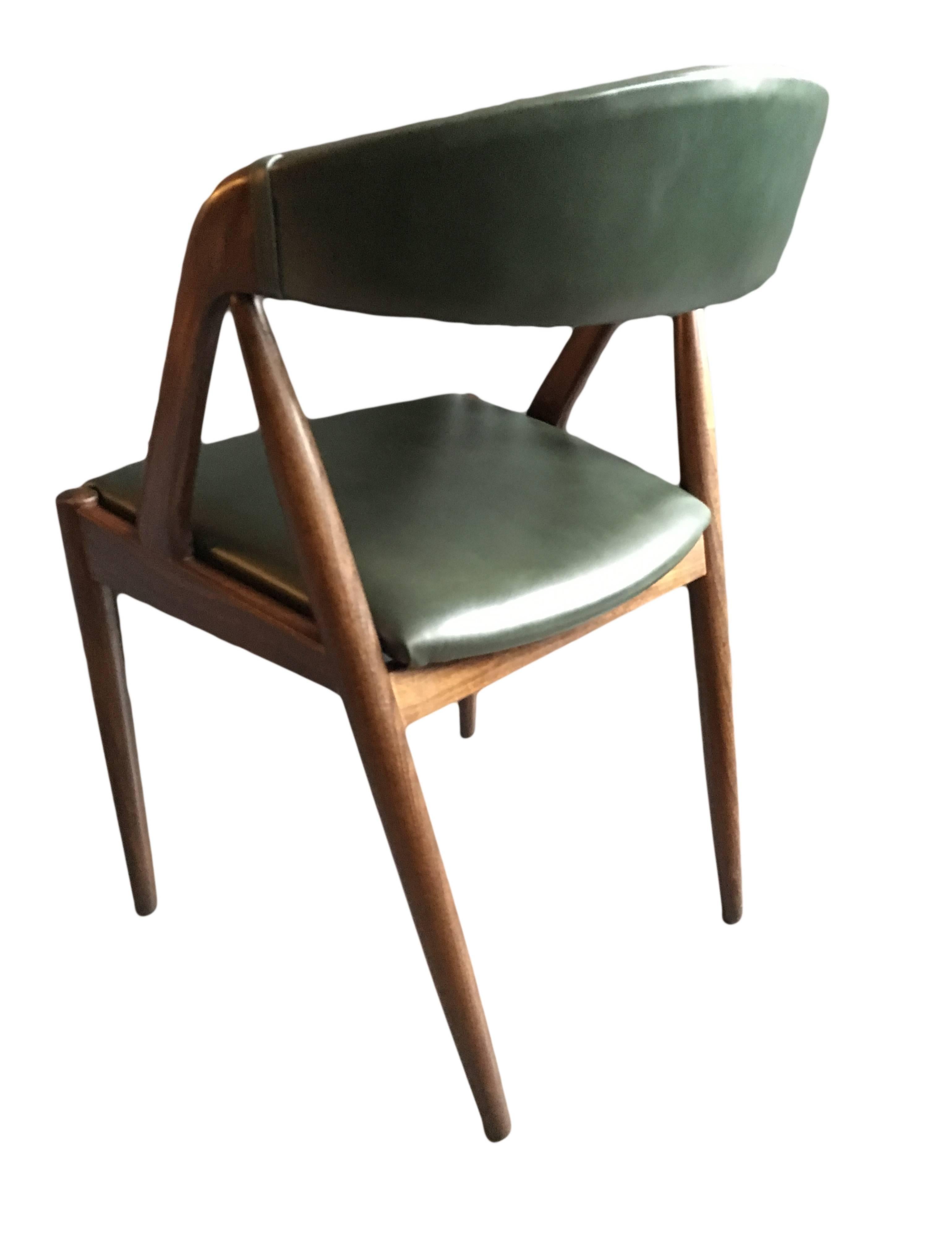 Set of six model 31 dining chairs by Kai Kristiansen. Fully re-polished and reupholstered in dark green Italian leather. Dark teak frames. Produced in Denmark, circa 1960.