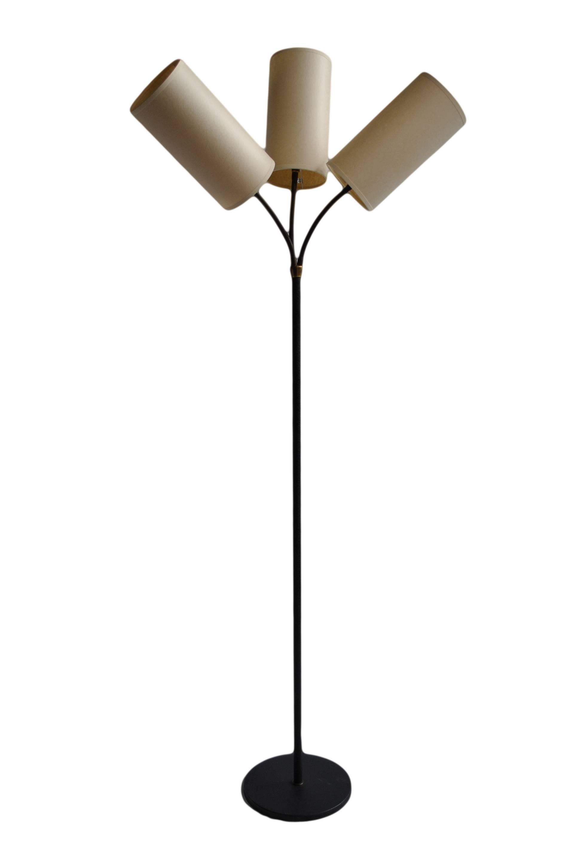 Danish three headed angle adjustable gooseneck floor lamp. Produced in the 1950s. This lamp has been fully rewired and has new style-appropriate shades (other colors available).
 