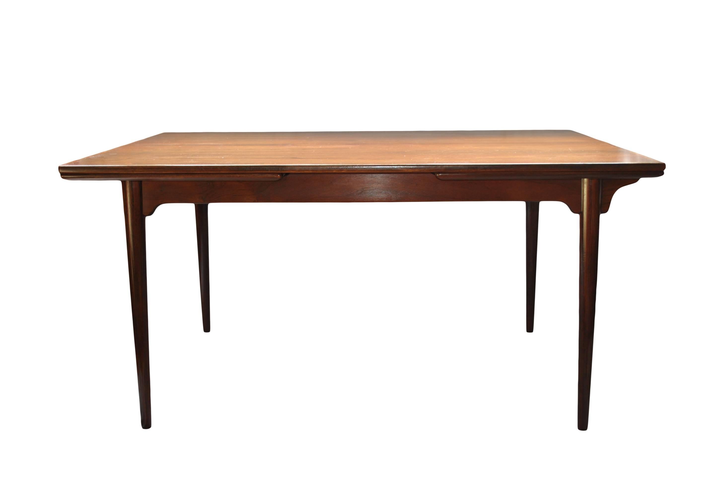 Danish Midcentury dining table designed by Gunni Omann for Omann Jun. Produced in Denmark, circa 1960. Refinished surface. Superb condition. Double pull extending leaves to a max of 240cm.
Easily dismantled and reassembled for safe transportation.
