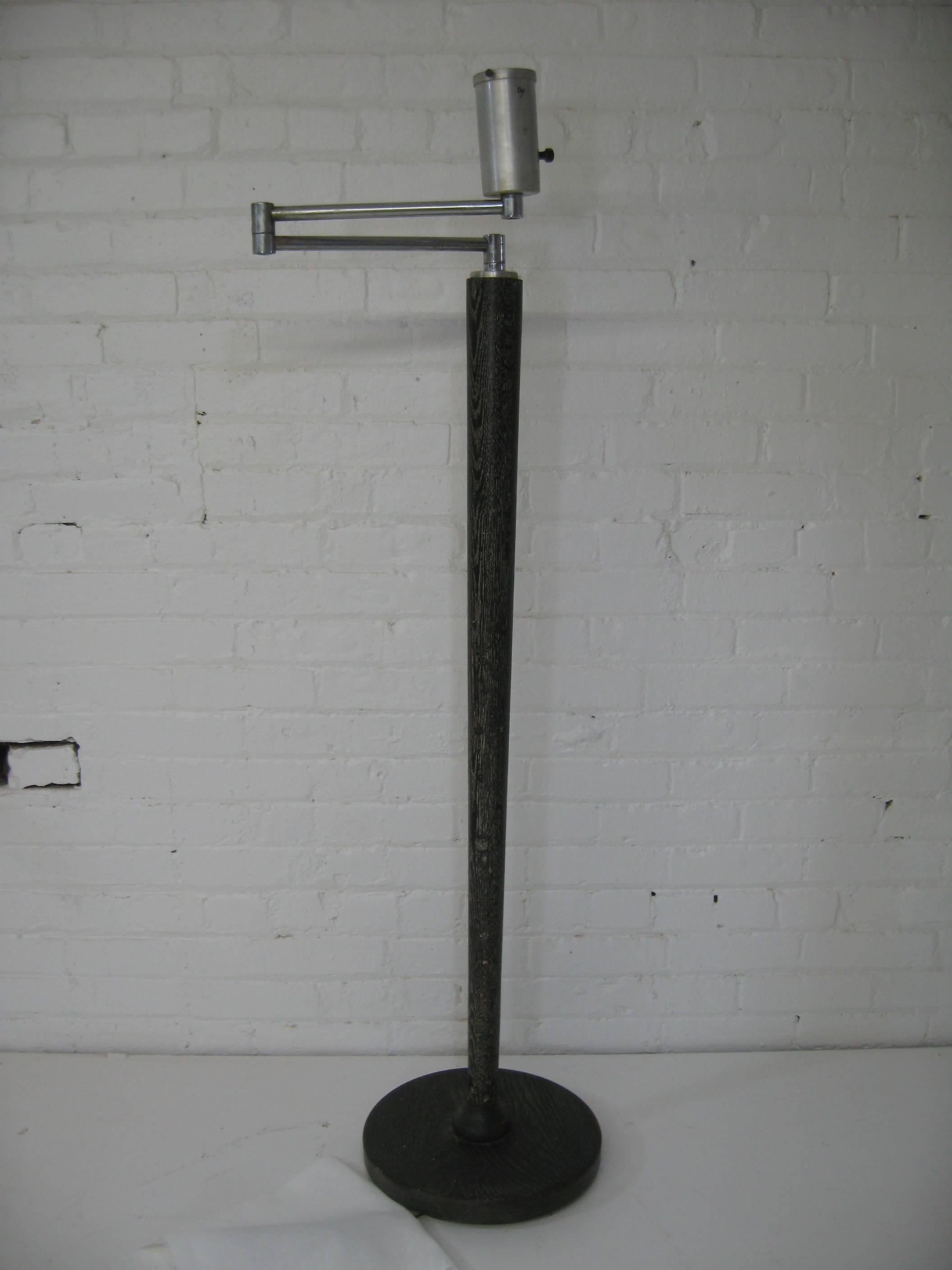 Moderne cerused and limed oak floor lamp, circa 1950. Large open oak grain is pronounced in white and contrasted in black. Tapered shaft design. Weighted iron base. Nickel extending and adjustable arm. No shade or diffuser, but has been re-wired.