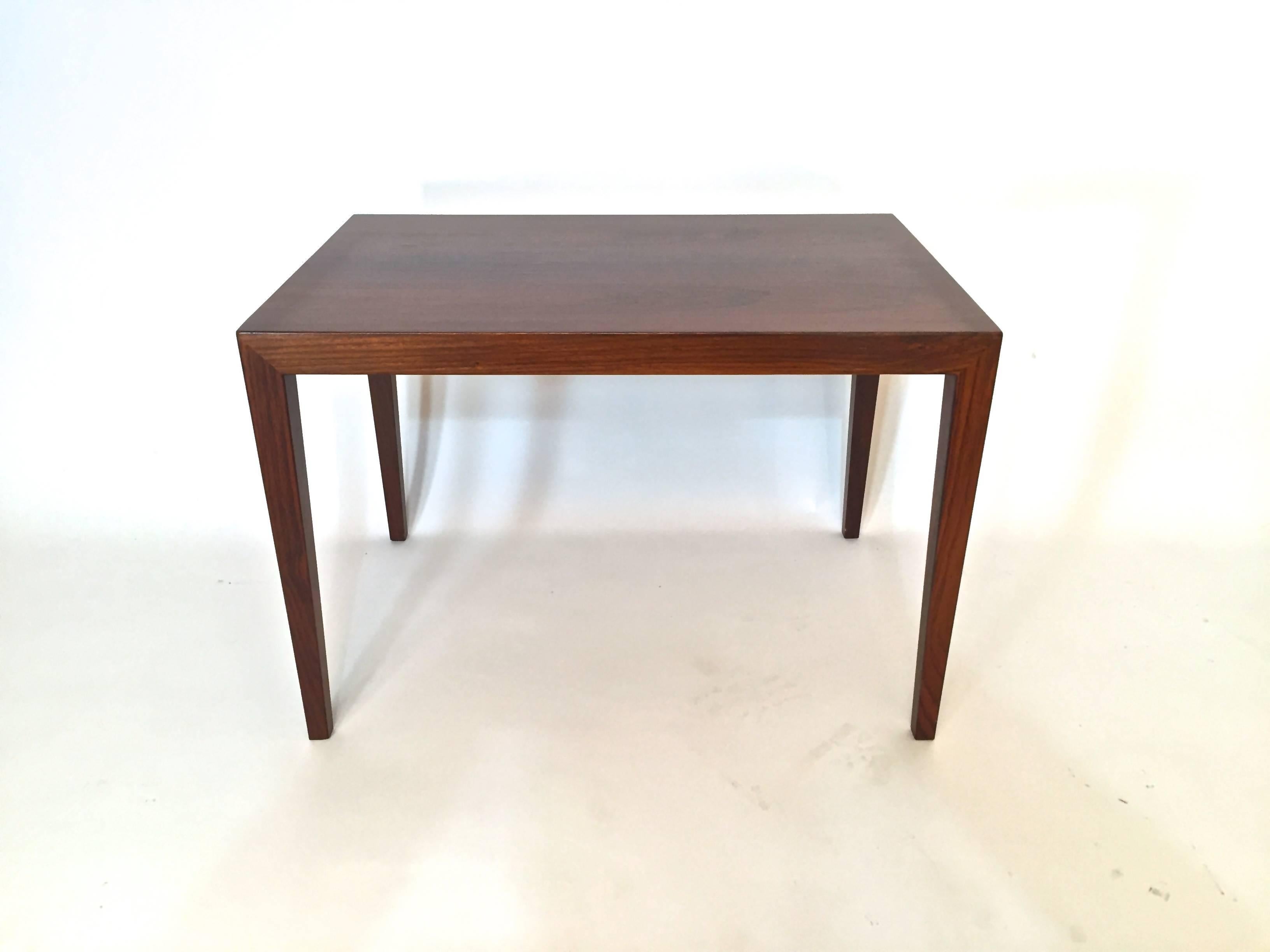 Severin Hansen design. Top of the line furniture was sold through the famous Danish department store, Illums Bolighus. Beautifully figured rosewood top with elegantly tapered rosewood legs. Good overall condition. Some crazing and dryness to the top