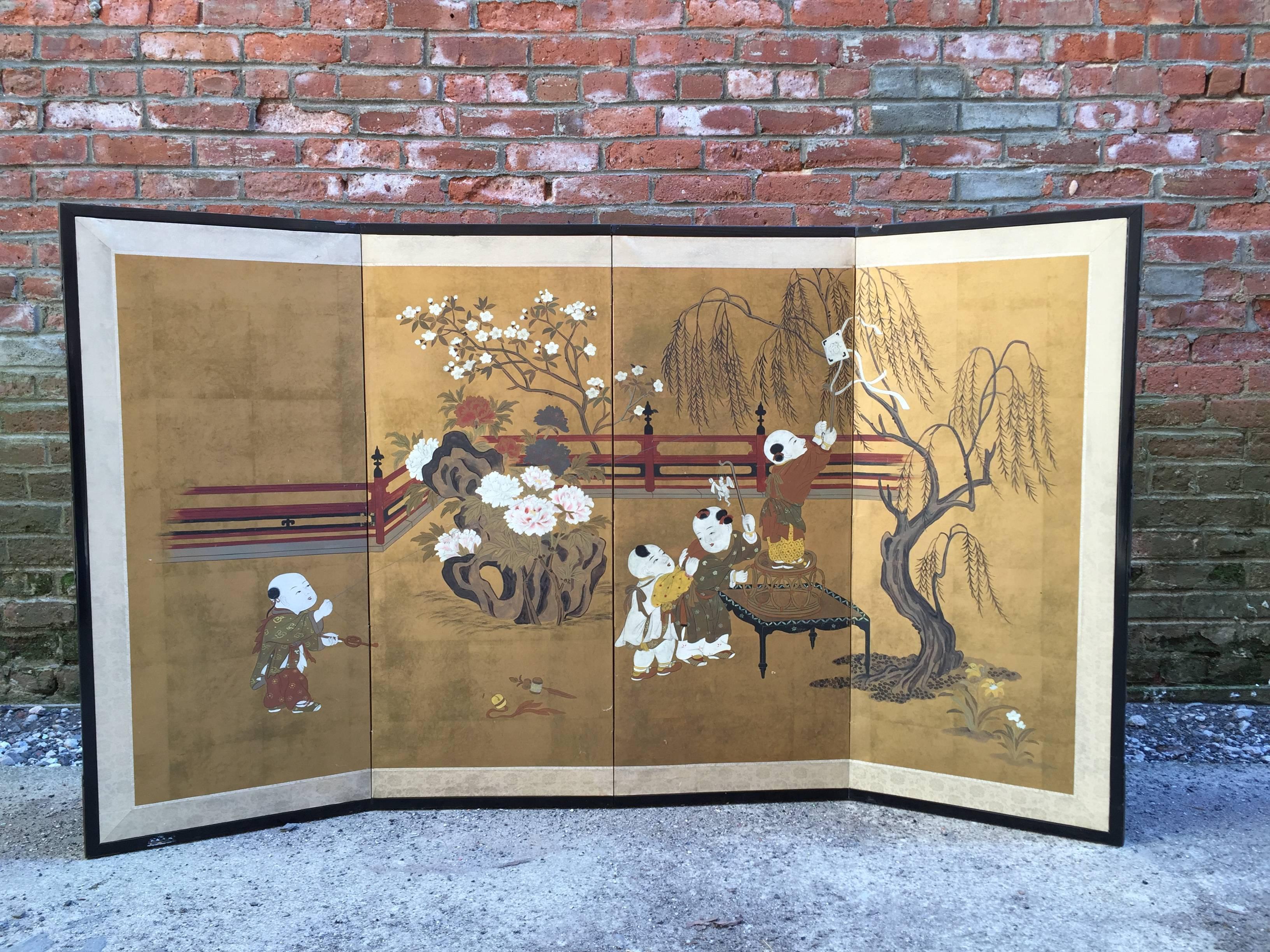 Intricately decorated Japanese folding screen. Hand-painted and gilded screen depicts four children at play; one is trying to fly a kite, one is retrieving the kite from a willow tree and two are in the process of playing keep away.

The