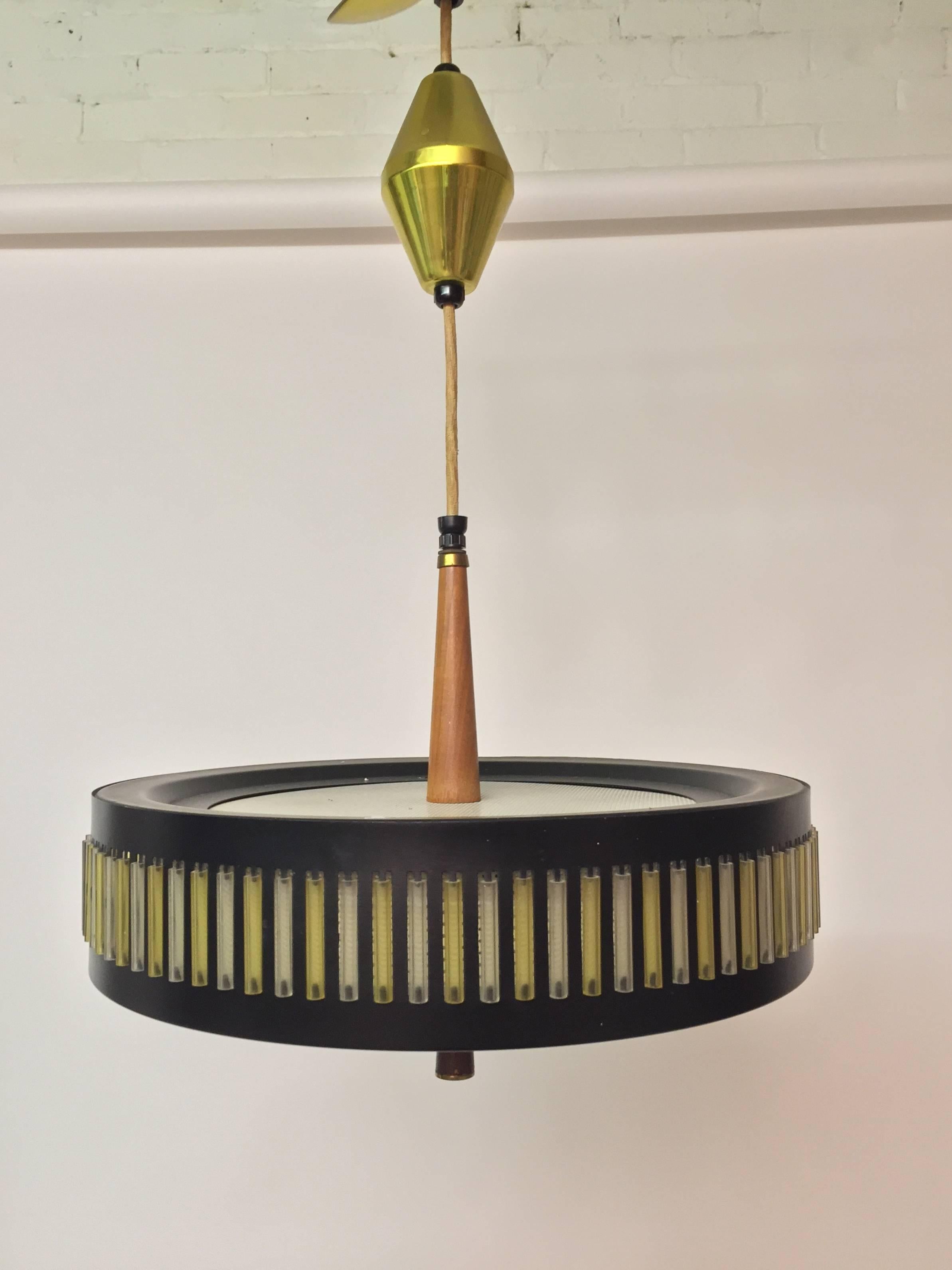 Classic Mid-Century Modern drop light fixture from Globe Lighting Products. The height is fully adjustable. All original details include the glass diffuser, solid walnut accents and yellow and clear plastic cylinders. Old fabric cord. 14