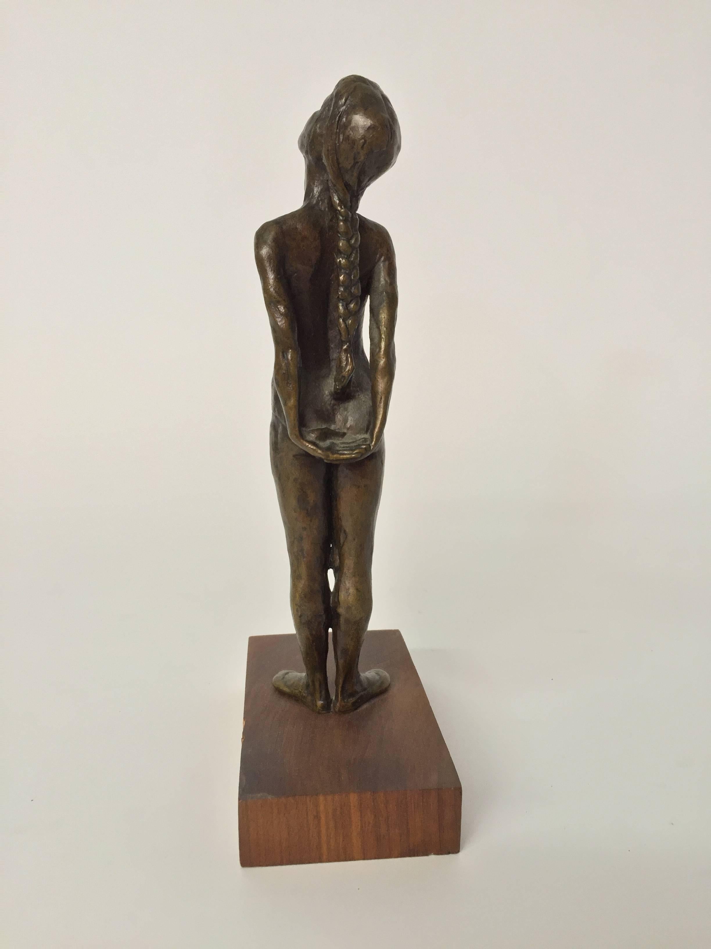 Finely casted ballerina bronze. Initialed in the casting, SGK. The artist has rendered her in a resting stretch position. The bronze is mounted to a solid walnut block base, circa 1960.
