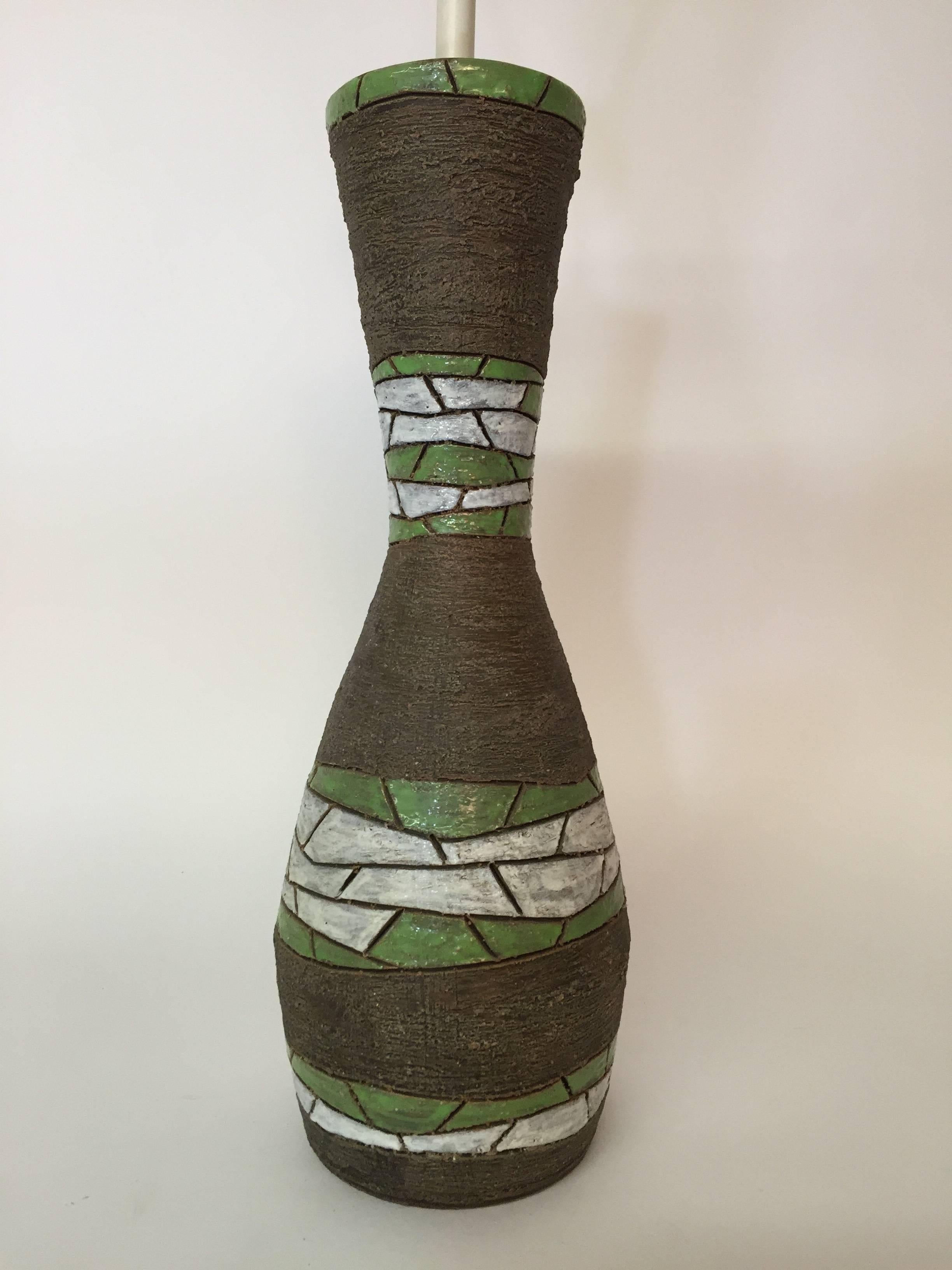 Curvaceous art pottery lamp for Raymor. Designed by Aldo Londi for Bitossi, circa 1950-1960. Glazed in matte brown and gloss white and green.

The pottery measures 17.75