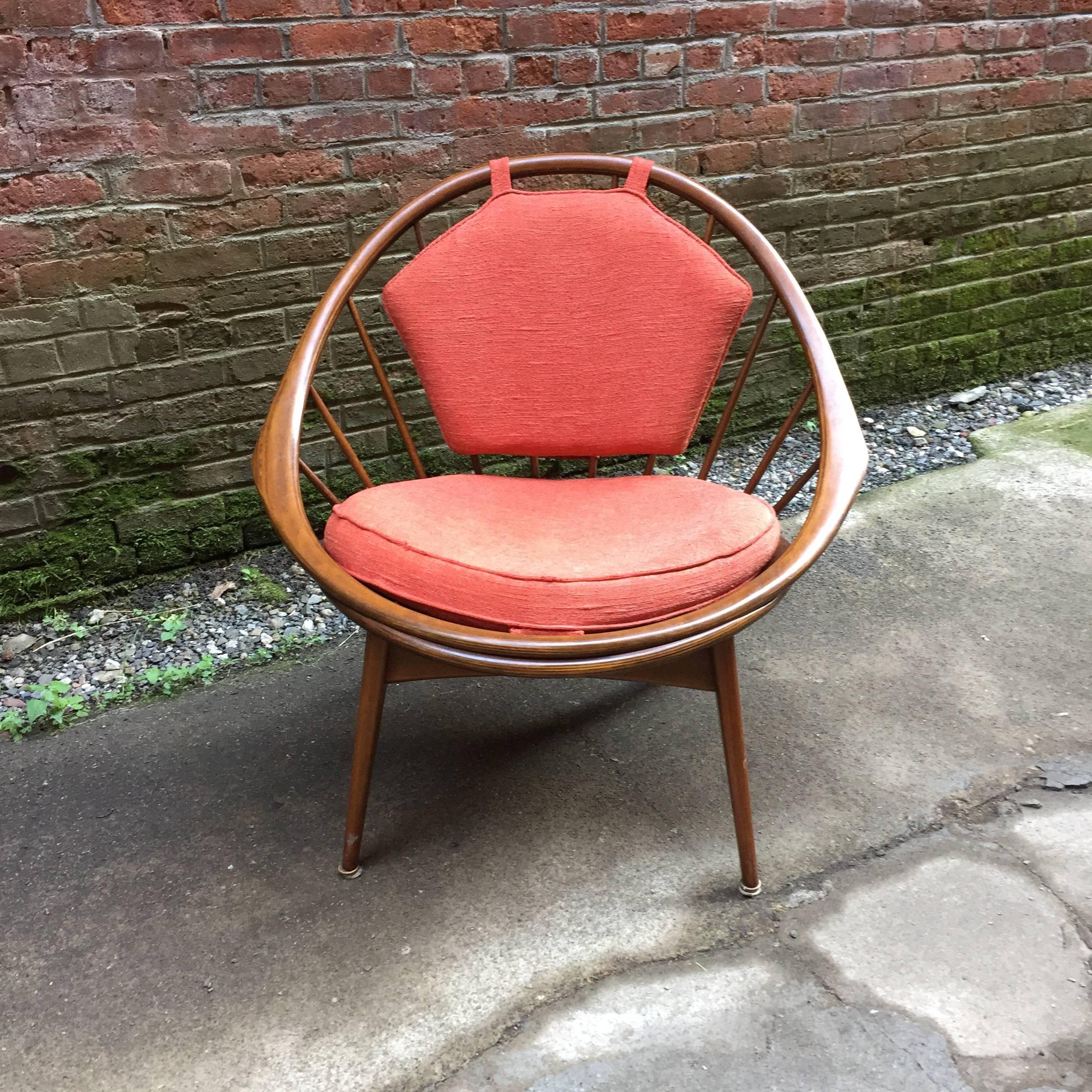 Graceful Ib Kofod-Larsen designed chair for Selig, Denmark. Fully signed with red and white enamel button tag. Walnut spindle back and flared legs. Original red fabric seat and back cushion, circa 1955-1960.