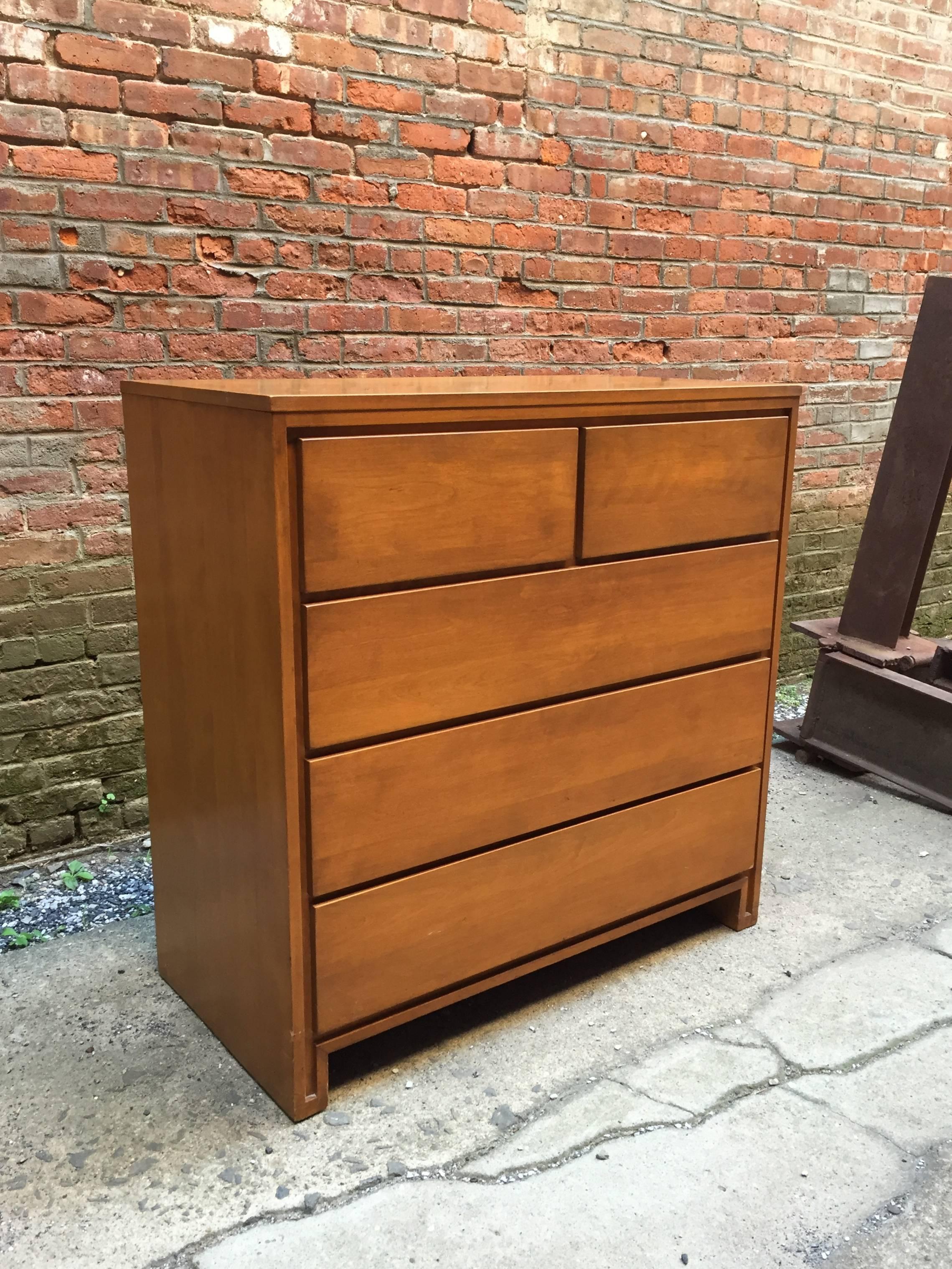 The design simplicity is either attributed to Leslie Diamond, but more famously, to Russel Wright for Conant Ball. Excellent durable and solid maple or birch construction. Two over three design. Burn in signature in top drawer.

Very good original