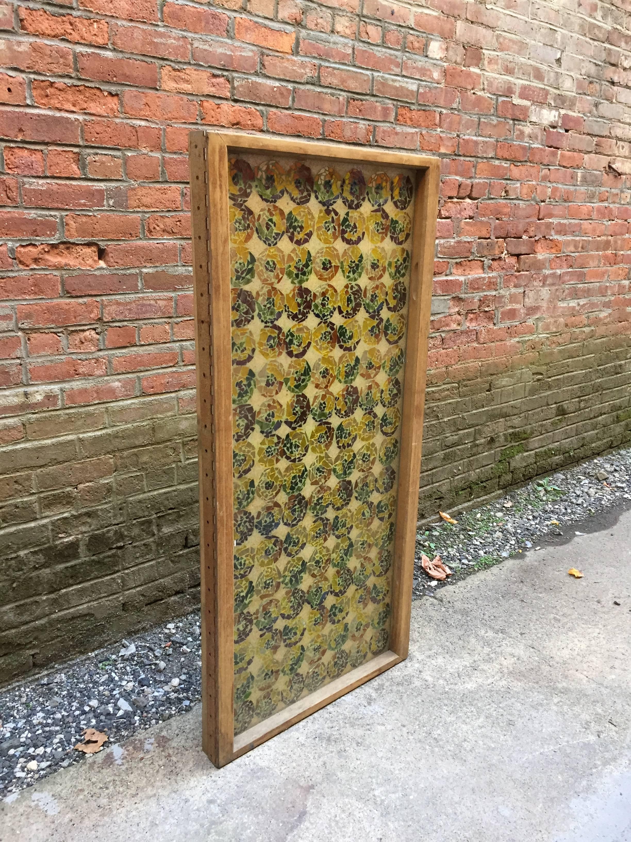Magnificent cased mosaic multicolored glass and sand window. There are 112 of these unique glass floral mosaics encased in sand and glass. Solid teak frame and one side has a fixed full length piano hinge attached. Labor intensive craftsmanship,