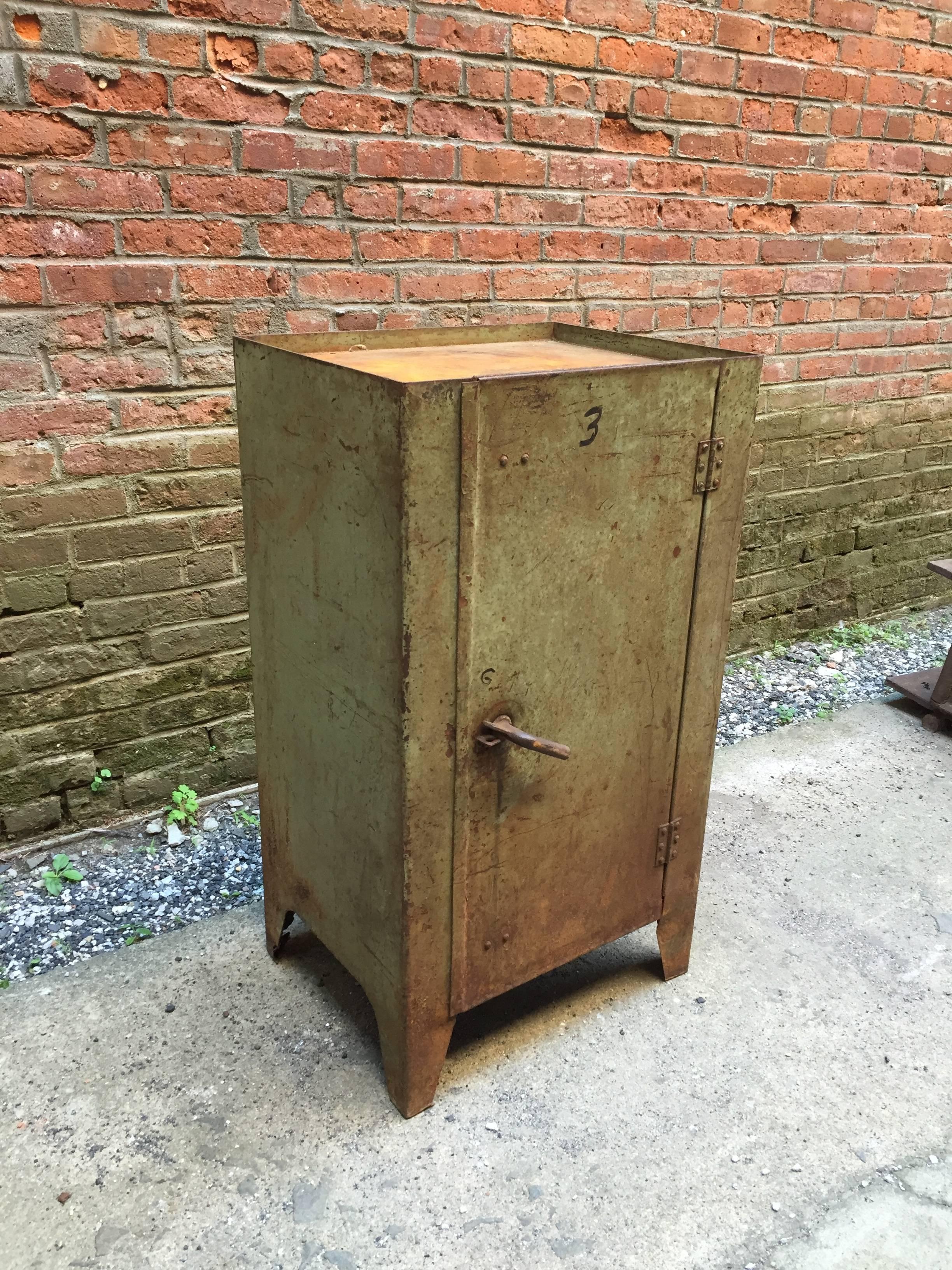Locking Industrial cabinet that is aged to perfection. Overall rust and Industrial green chipped paint. Spectacular twist handle, circa 1930-1940.