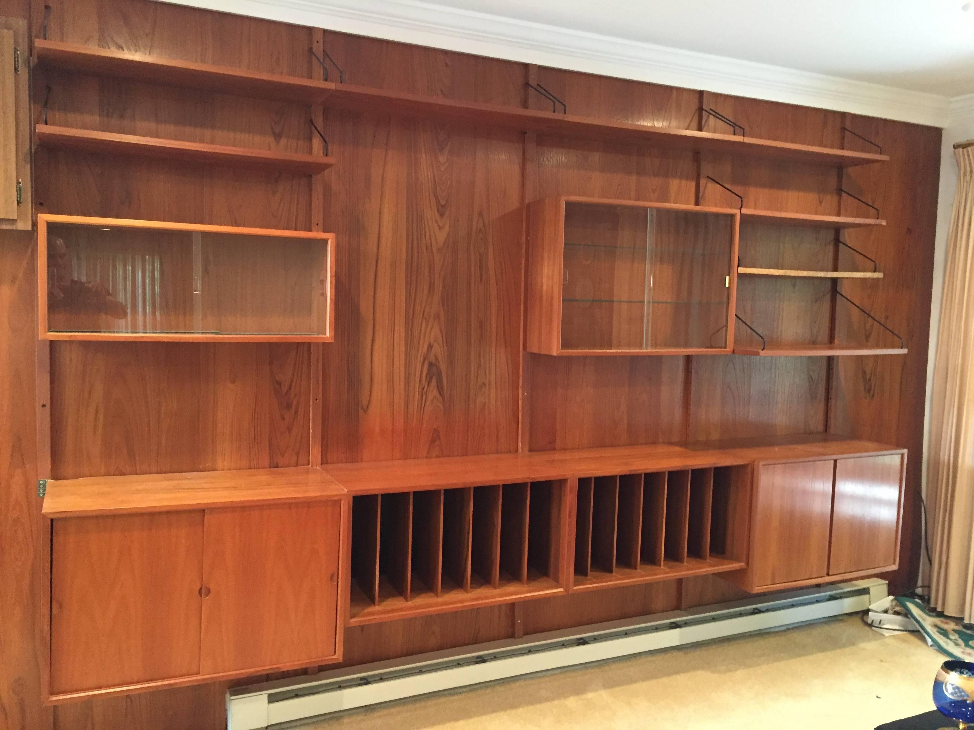 Series of teak shelves and cabinets designed by Poul Cadovius for Royal System, Inc., Denmark. These shelving units are wonderful space savers and can be mixed and matched and re-arranged for all your storage needs. This system contains 8 shelves,