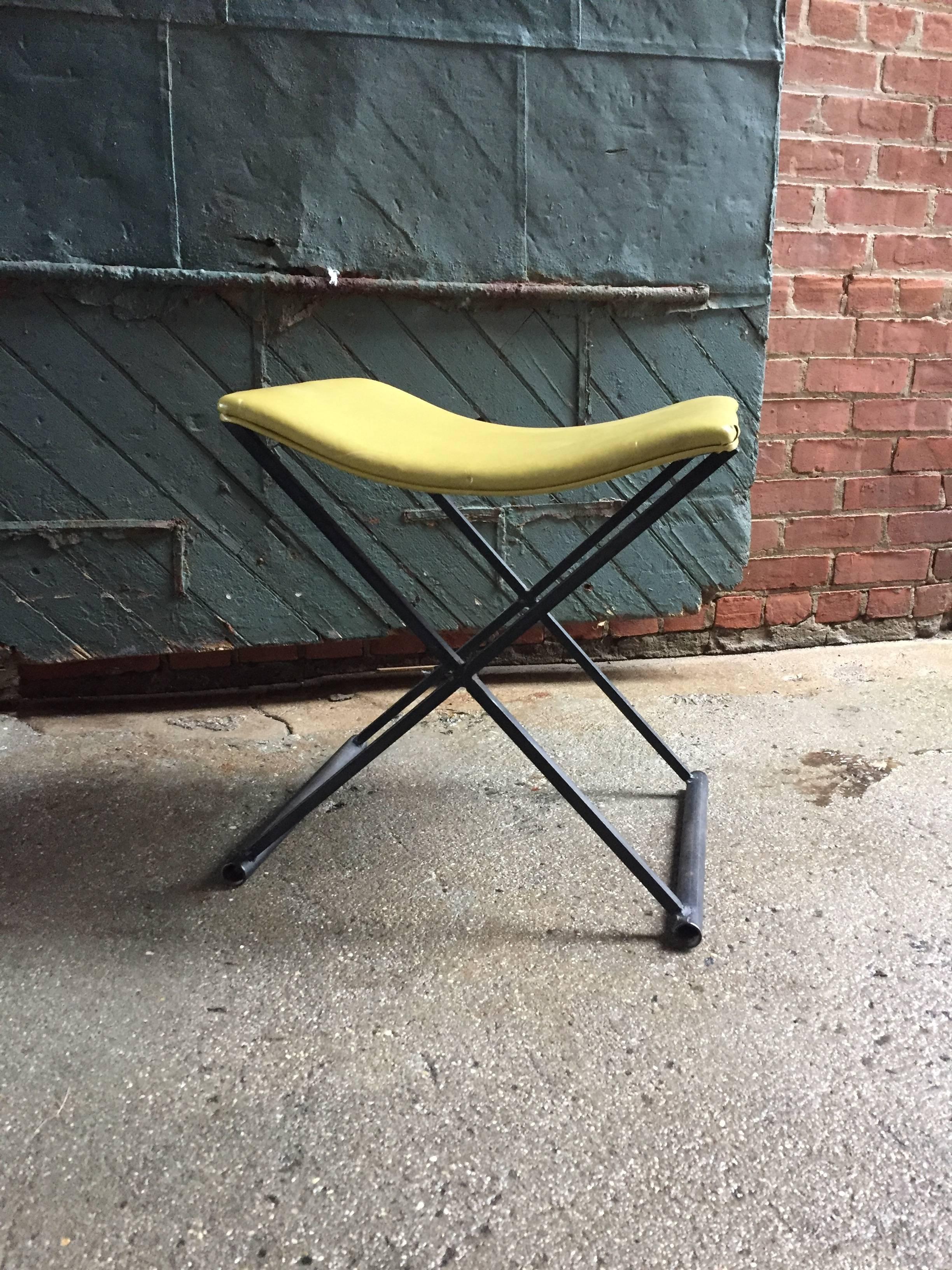 Original yellow vinyl concave seat resting on a black lacquered X-base steel frame. Great accent piece.