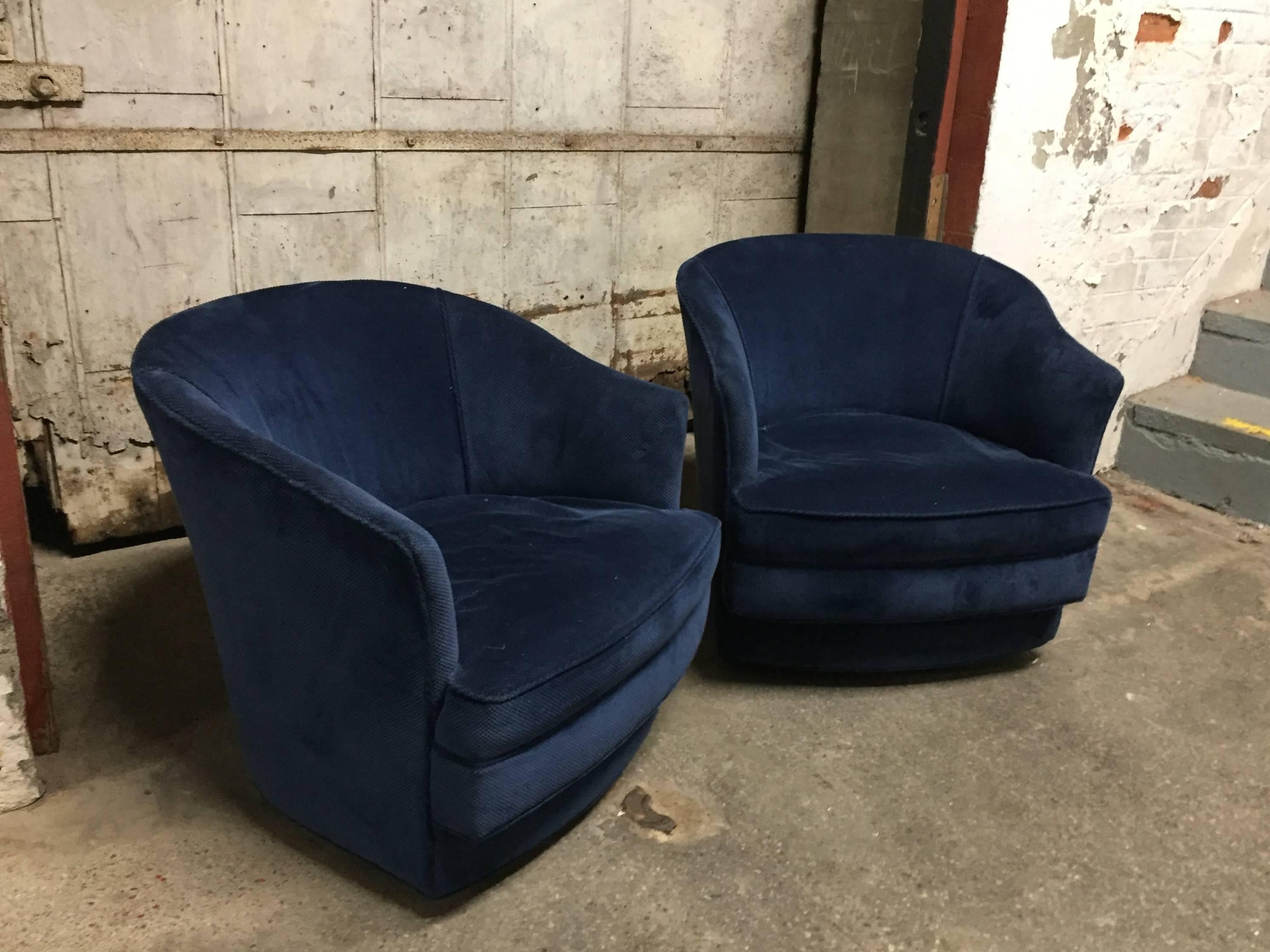Pair of fabric upholstered swivel chairs that retailed from John Stuart, circa 1967. Labeled on the underside and dated. Comfort and small-scale. They both come with two throw pillows.