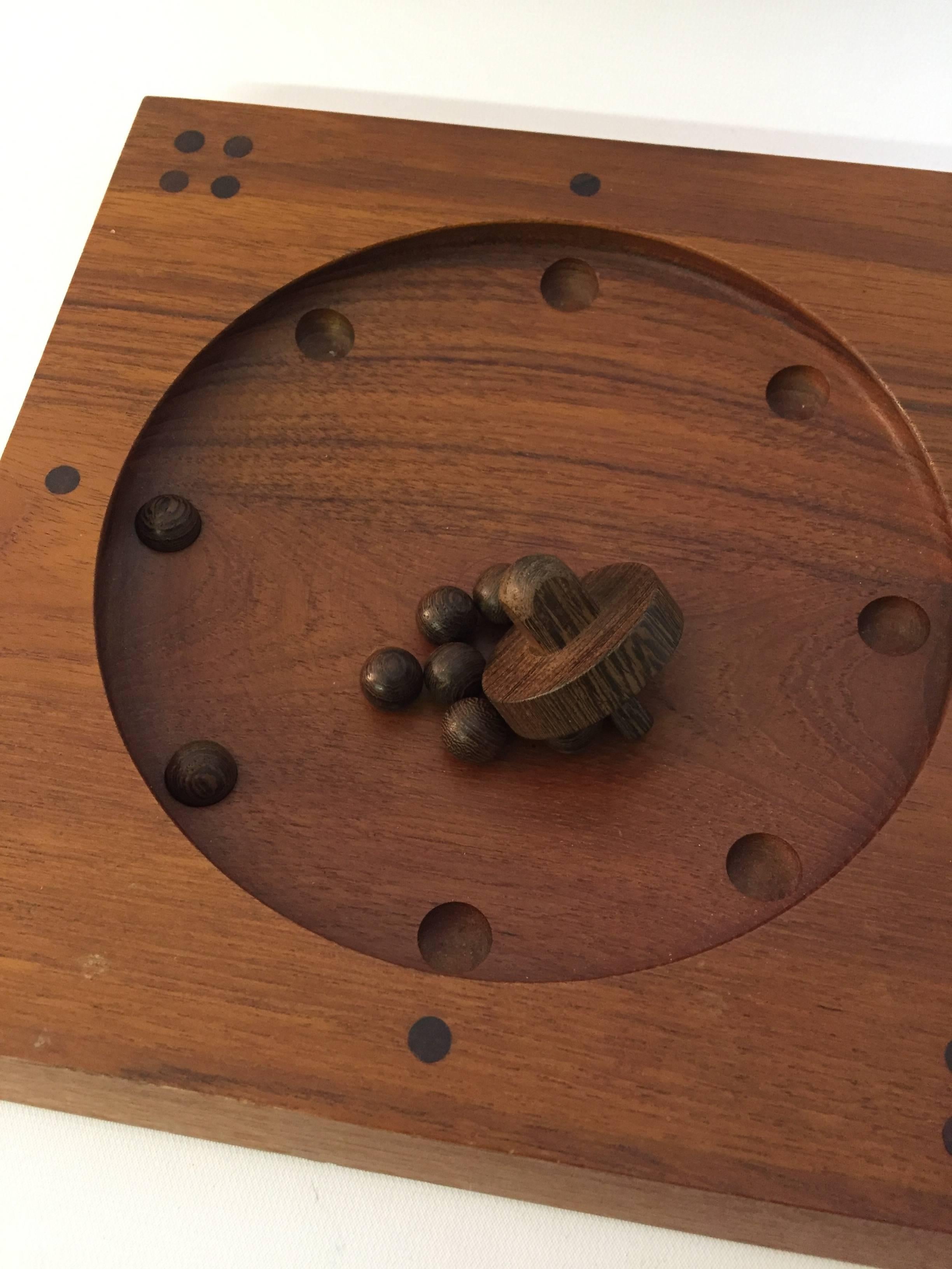 Beautifully designed roulette board game in teak, rosewood and wenge wood by Thomas Skjode Knudsen. Complete with wenge top and balls in a leather pouch. Complete with easy instructions.