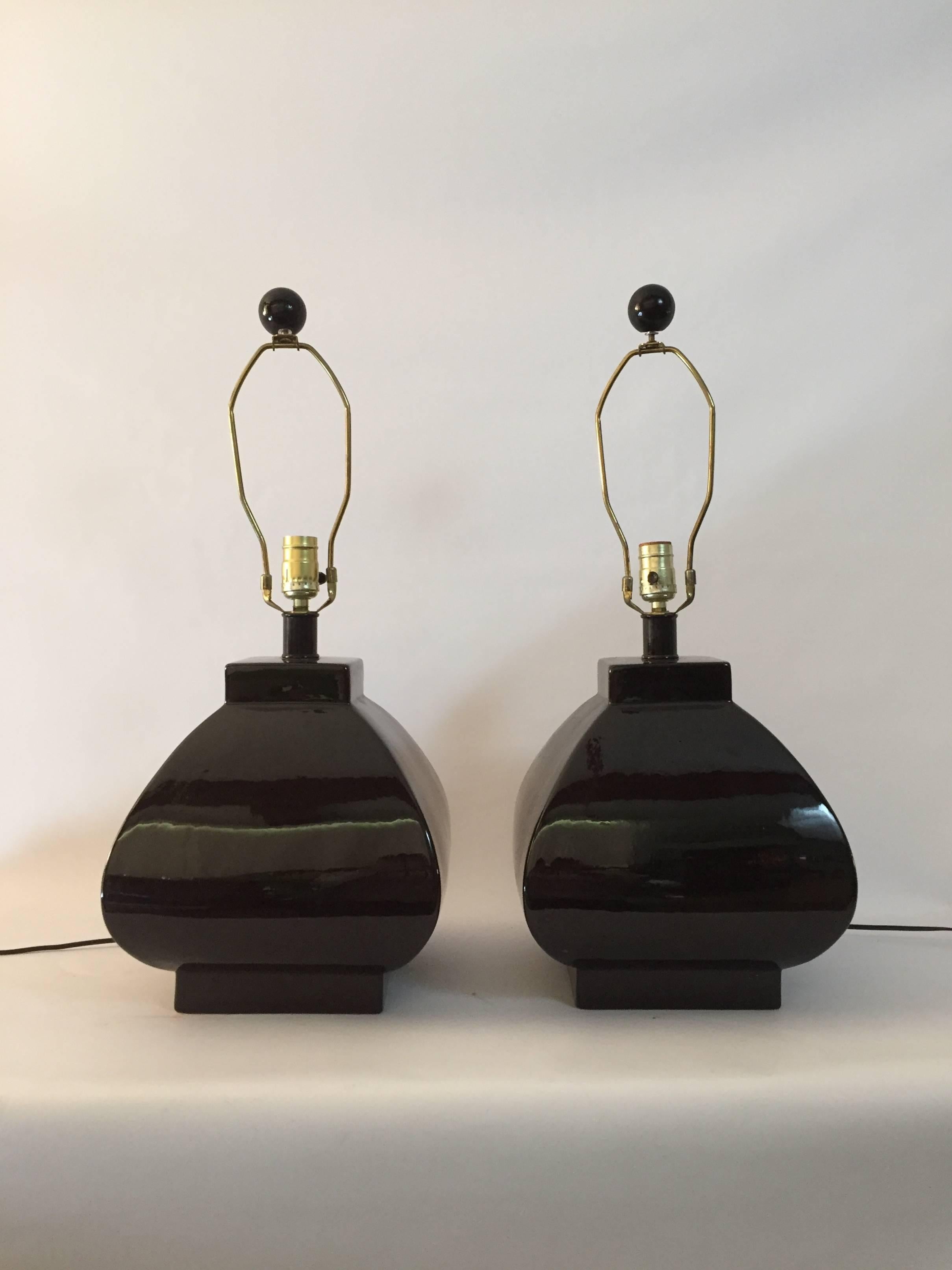 Beautiful pair of Postmodern high gloss black glazed lamps. Fully working condition with old wiring, circa 1970-1980. Felted bottoms. Shades for photography only. Shades not included.

Overall height from base to finial is 26