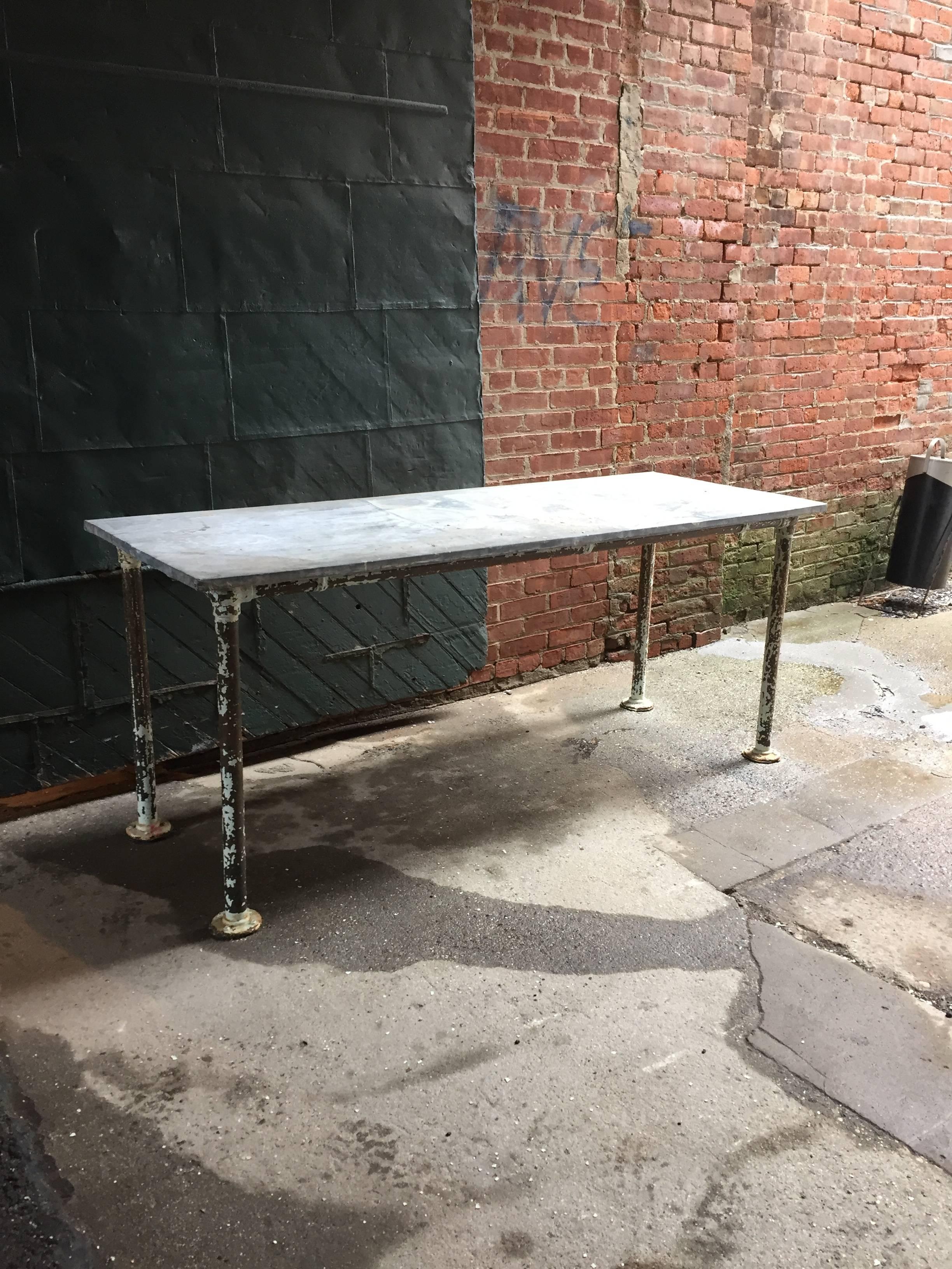 Straight out of the science lab. Constructed from galvanized zinc clad wood top with heavy duty steel pipe legs and frame. Well used as a work table; it has the proper amount of distress, wear, oxidation, use and surface paint loss. Remnants of