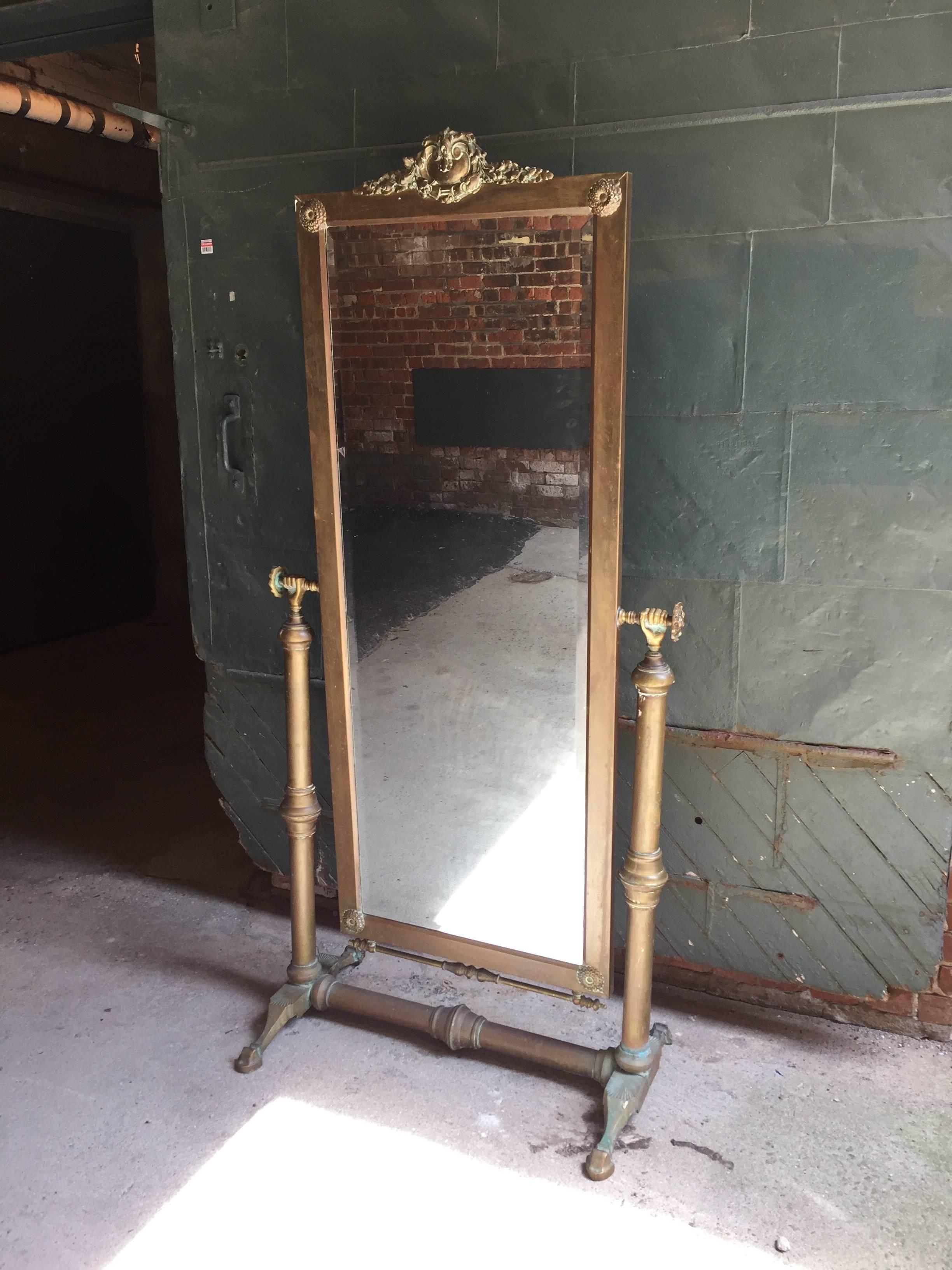 Beautiful cast brass and bevelled cheval mirror by Glo-Mar Artworks, New York. Unsigned, but the casting, motif and quality are the same as most Glo-Mar pieces.

Very good, original condition. Old dark patina.

Measures: 68