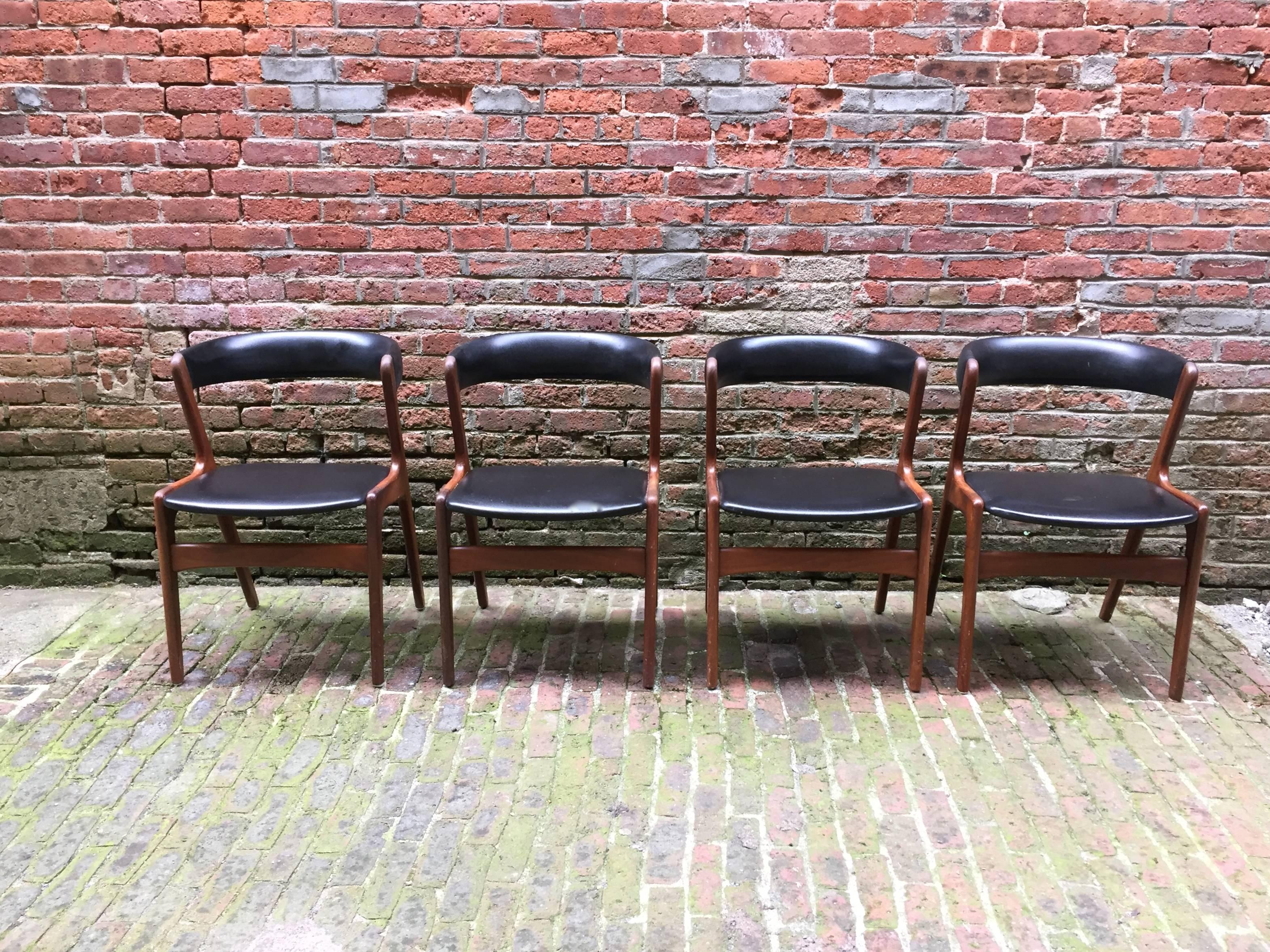 Solid teak design with black leatherette backs and seats. Structurally sound and in very good original condition. Designed for maximum comfort.