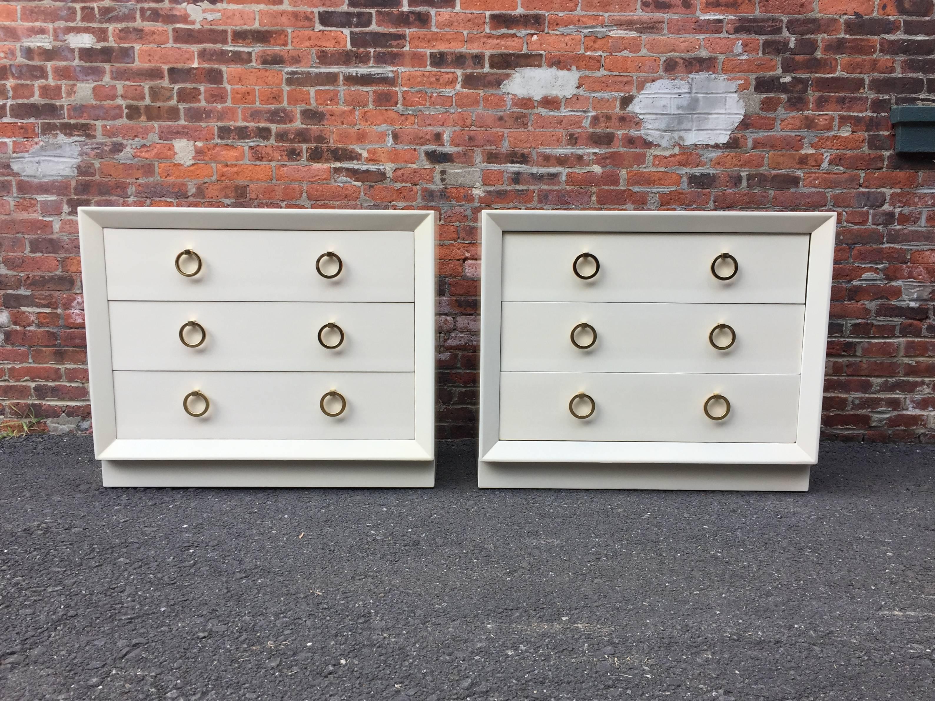 Pair of Terence Harold Robsjohn-Gibbings (1905-1976) dressers for Widdicomb. Deep three drawers with solid brass ring pulls. Plinth base with beveled front edge detail. Small hidden compartment under top drawer for securing valuables, etc. Paper