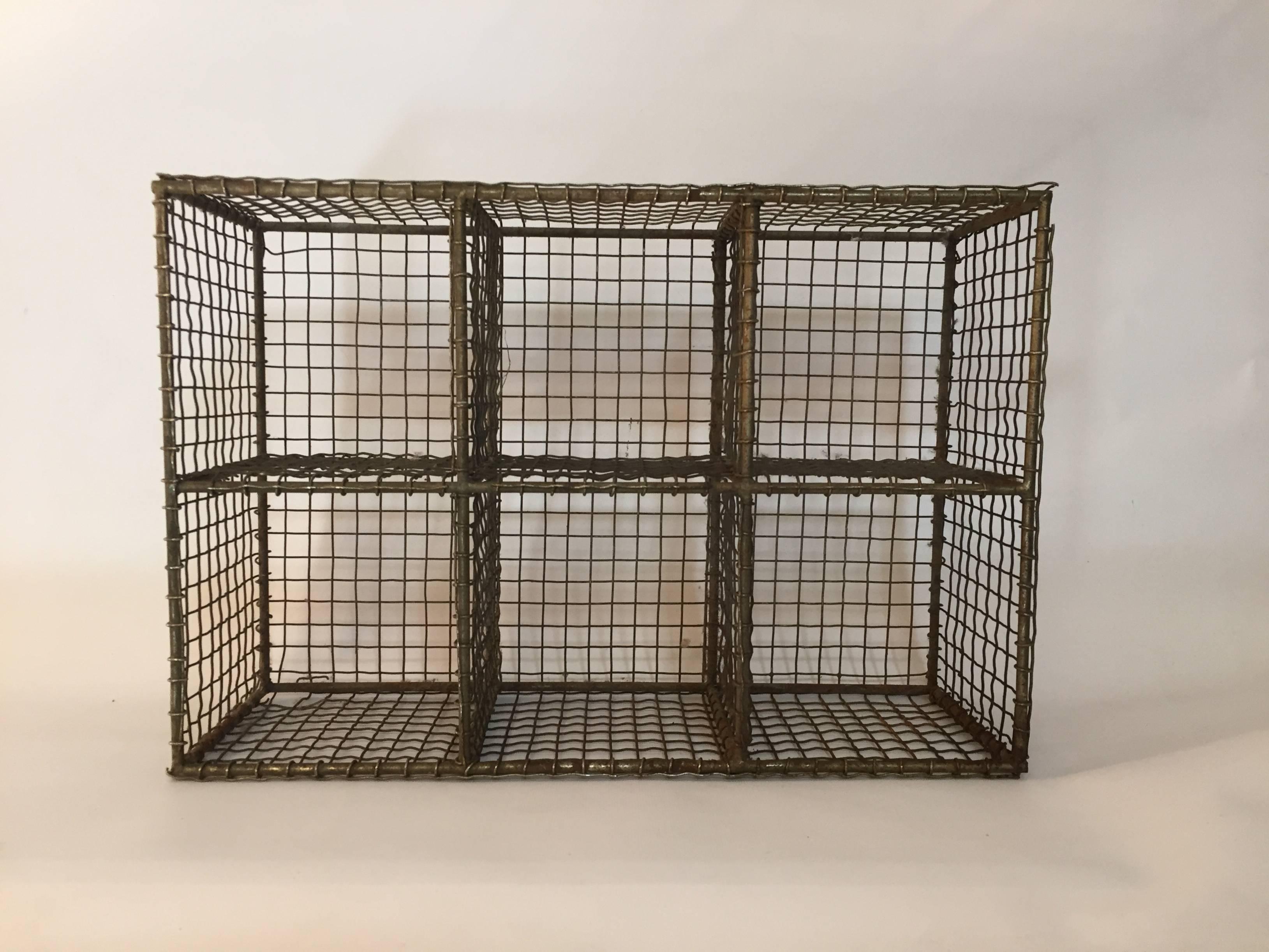 Six square compartments made up of galvanized wire and steel rod. Each compartment measures 5.38" x 5.38". No hangers, so it can be used as a table top piece or hung on a wall.