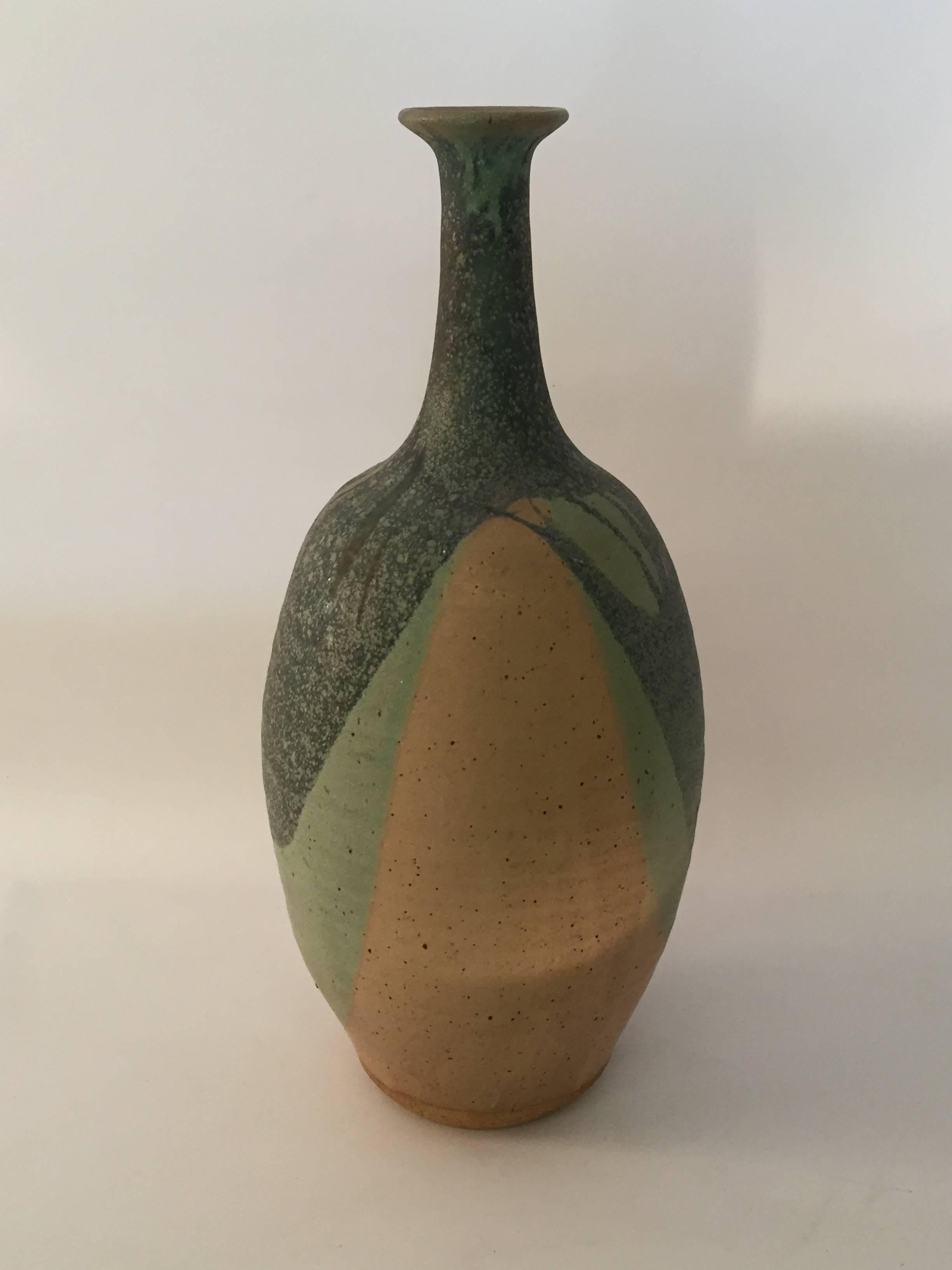 John Masson's pottery is in many prominent permanent private and museum collections here in the United States. This particular piece was exhibited in 1969 at the Jorgensen Exhibit Hall at The University of Connecticut. Multiple matte glazes adorn