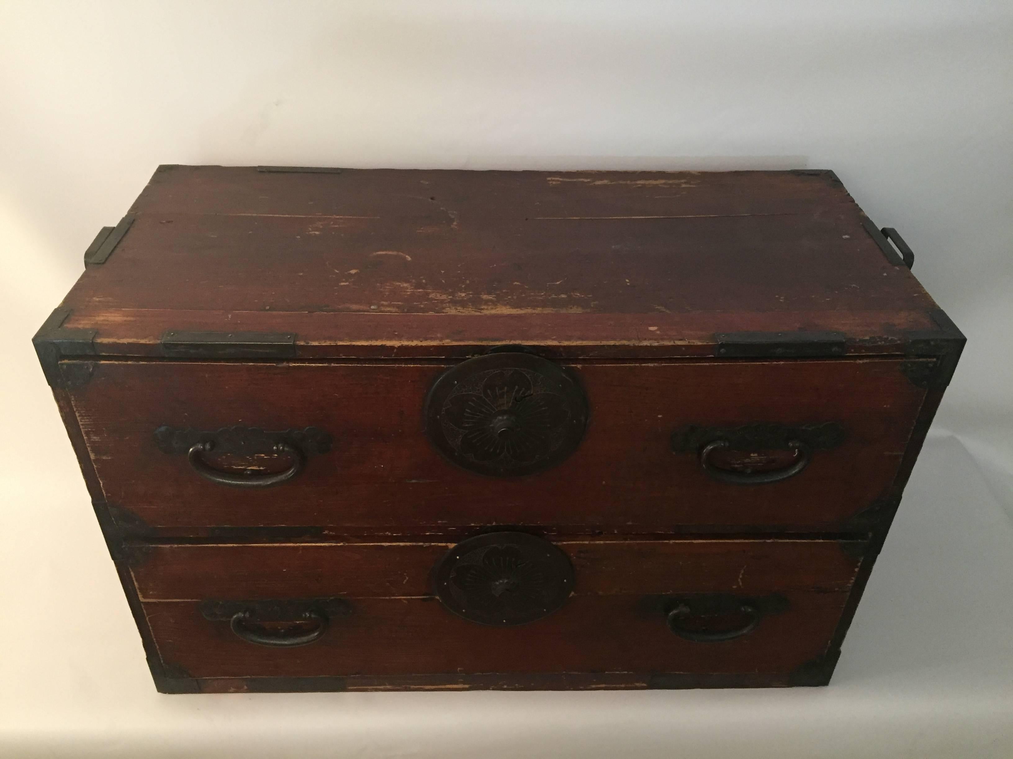Gorgeous two-drawer wood and iron Japanese tansu. One half of an original two-section tansu. All original hardware and original deep red finish. Dowel drawer dovetailing. This is one half of an original two-section tansu. 


Measures: 16" deep