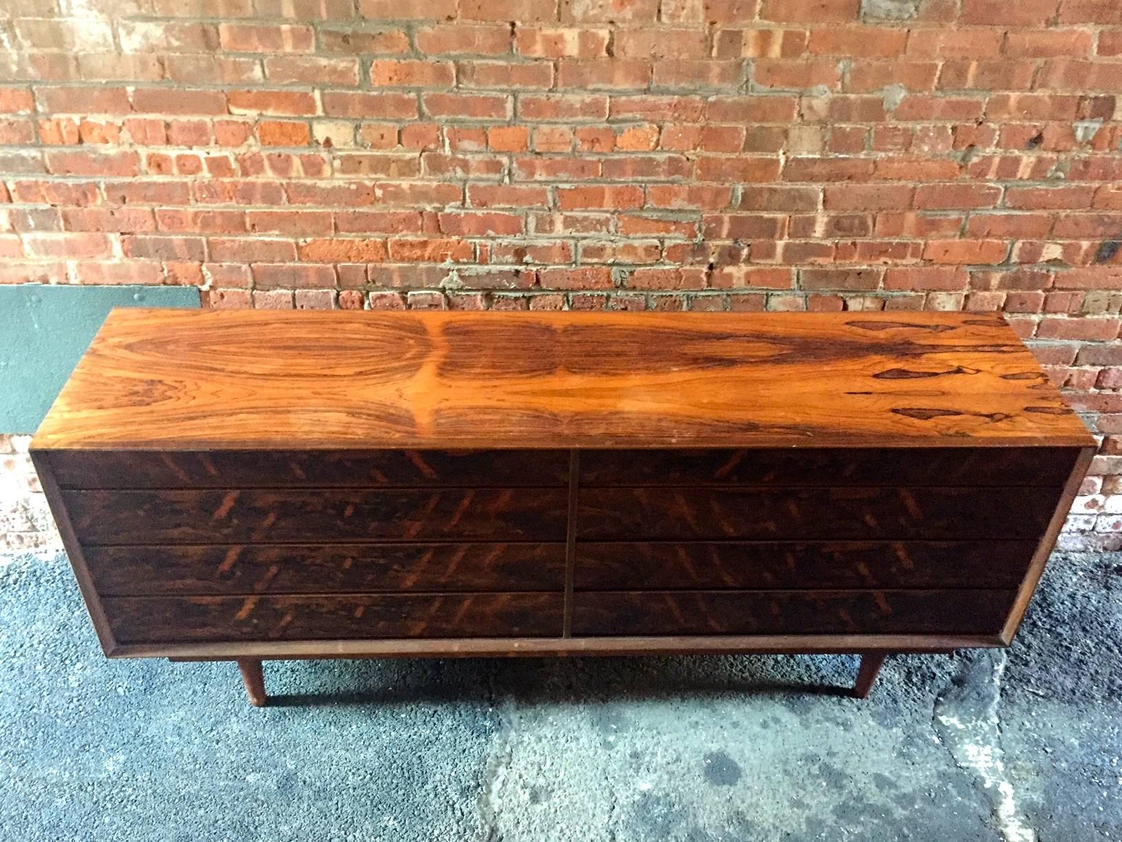 Eight-drawer rosewood double dresser. Finished on all sides. Beautiful book matched veneers. Danish control metal tag.

Measures: 78.75