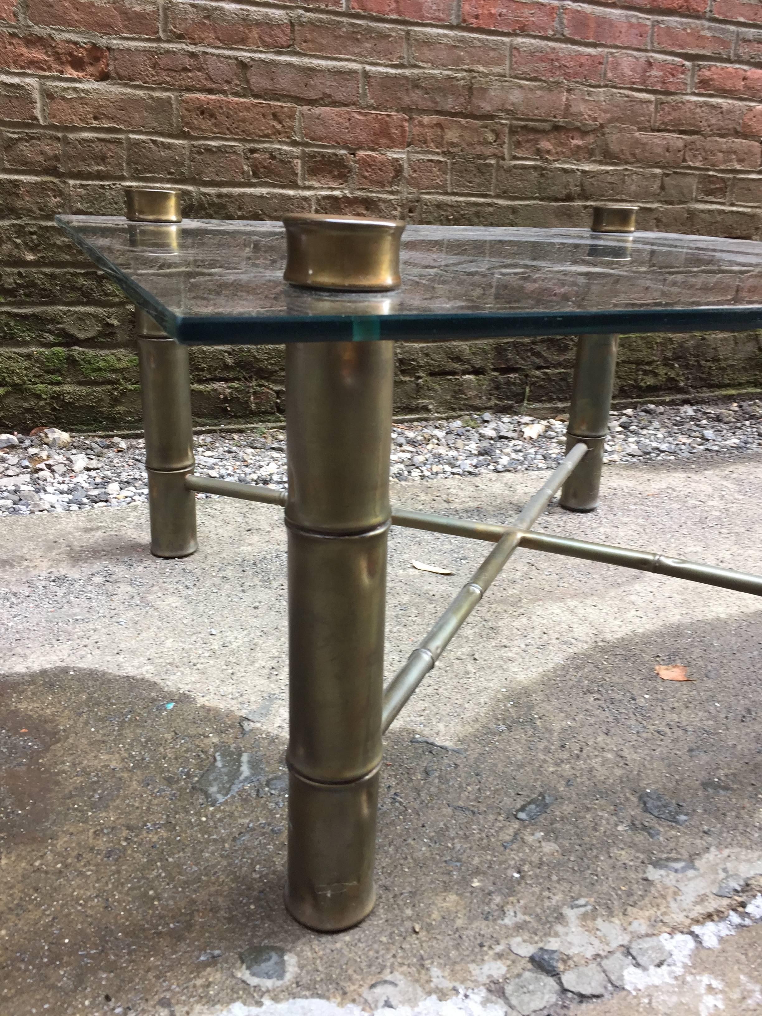 Brass legs with glass top coffee table. Circa 1970. Mellow old patina to the brass legs.

32