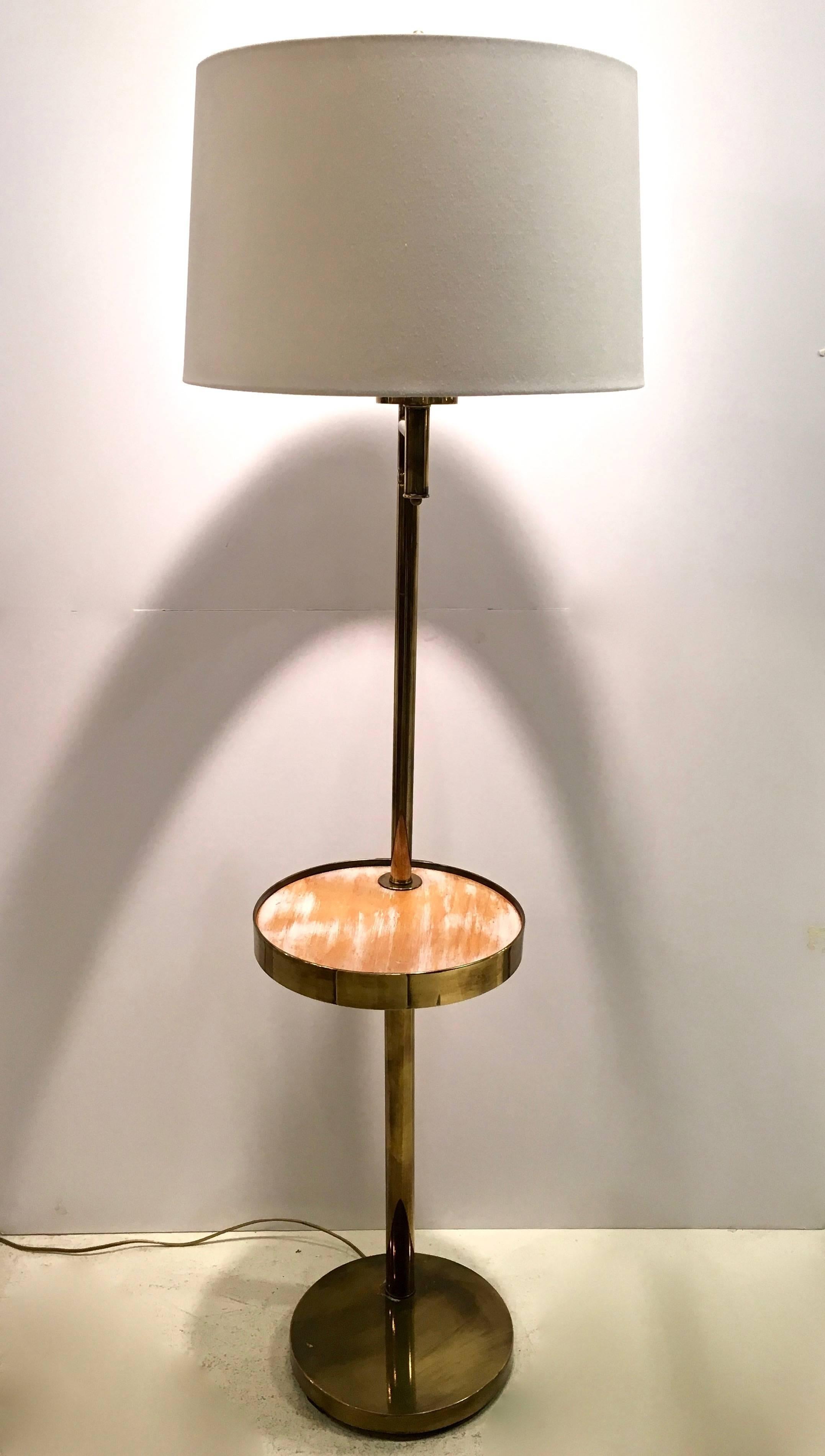 Beautifully and substantial patinated brass standing floor lamp. Swivel tray has a cerused wood tray table for drinks. Newly rewired and drum shade included.