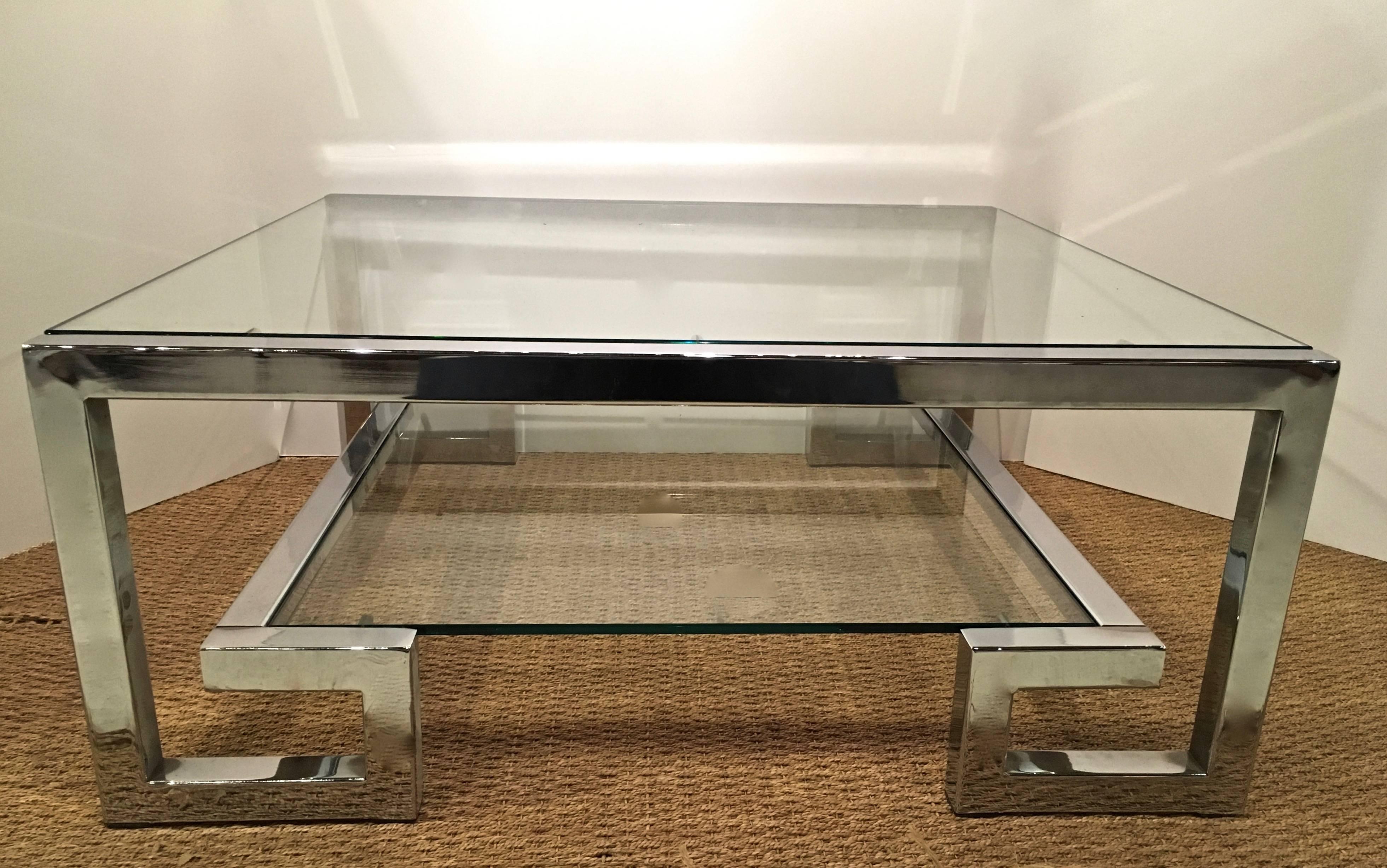 Really chic two level glass and chrome cocktail table. Graphic Greek key chrome frame curves up to allow for a second glass lower shelf. New glass inserts in excellent condition. Manner of Milo Baughman or Romeo Rega.
  