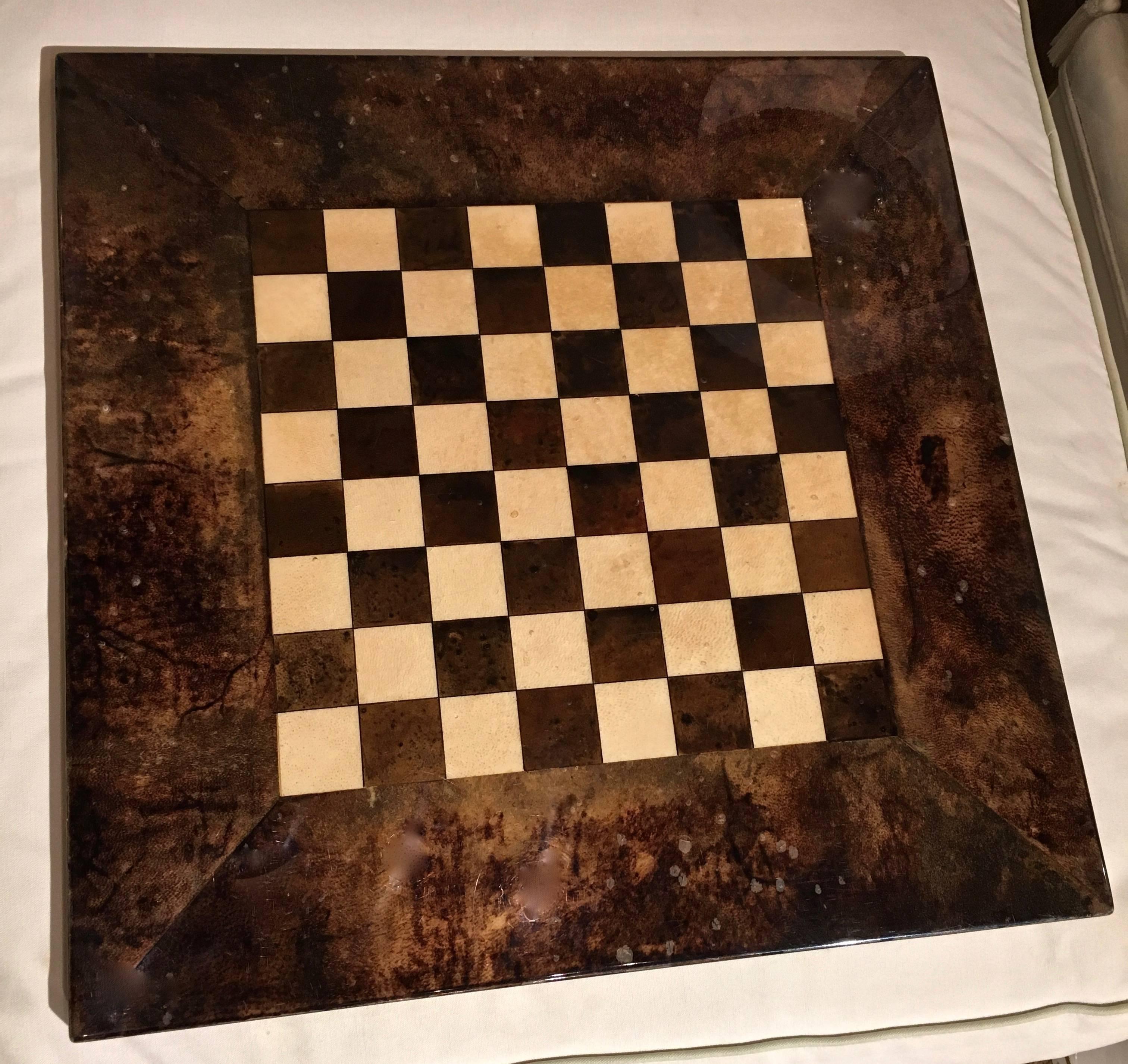 Unique lacquered goatskin chess board by Aldo Tura. Labeled on bottom. Mall imperfections to lacquer (lifting) in small dots on tip surface. No chips just appears as mottled specs (see images).
                   