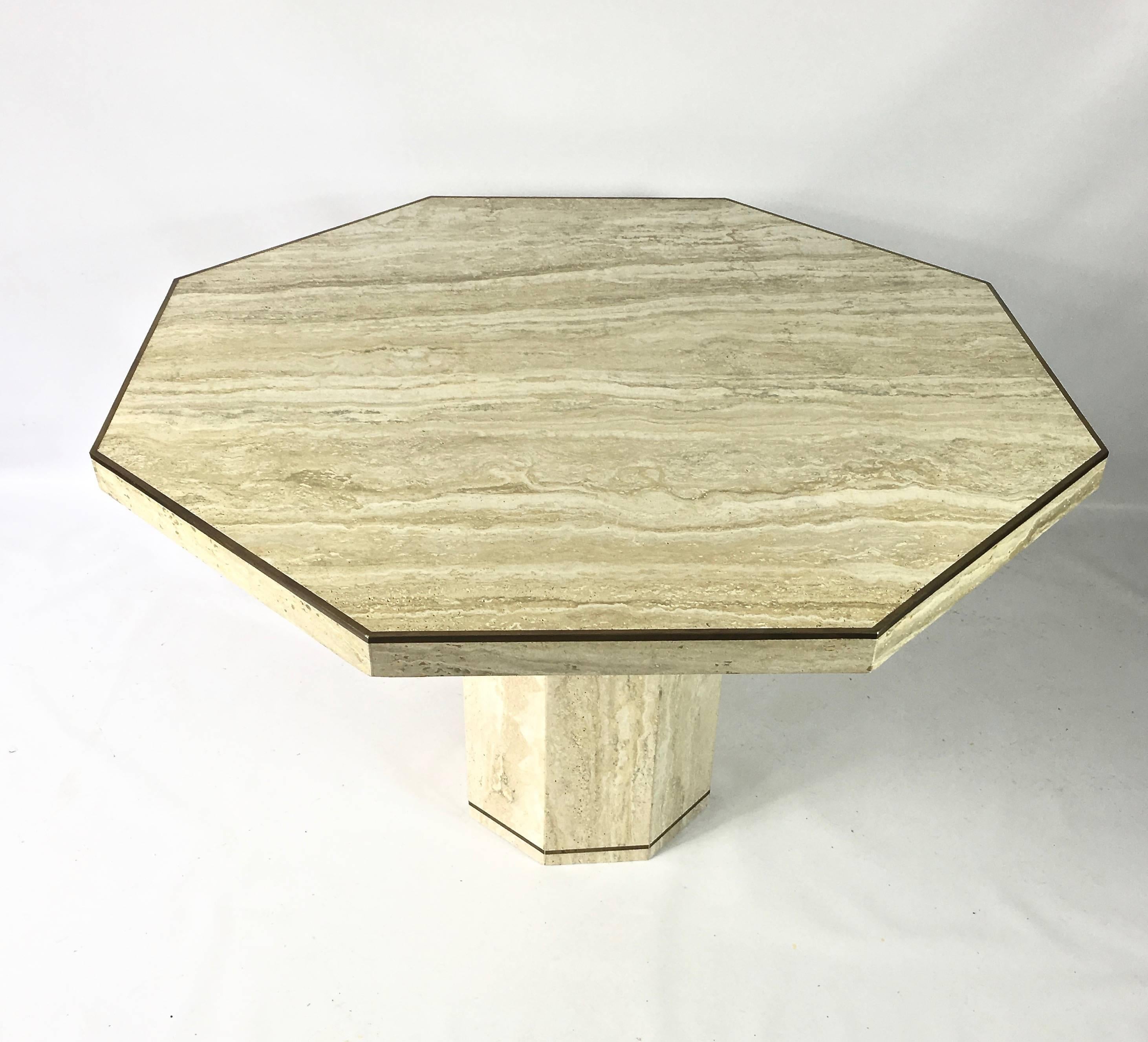 Stunning octagonal slab of travertine marble edged with a brass edge, sits upon a Travertine pedestal base, with a inlaid brass detail. Original Ello Label on bottom, made in Italy.

Base is 14.5