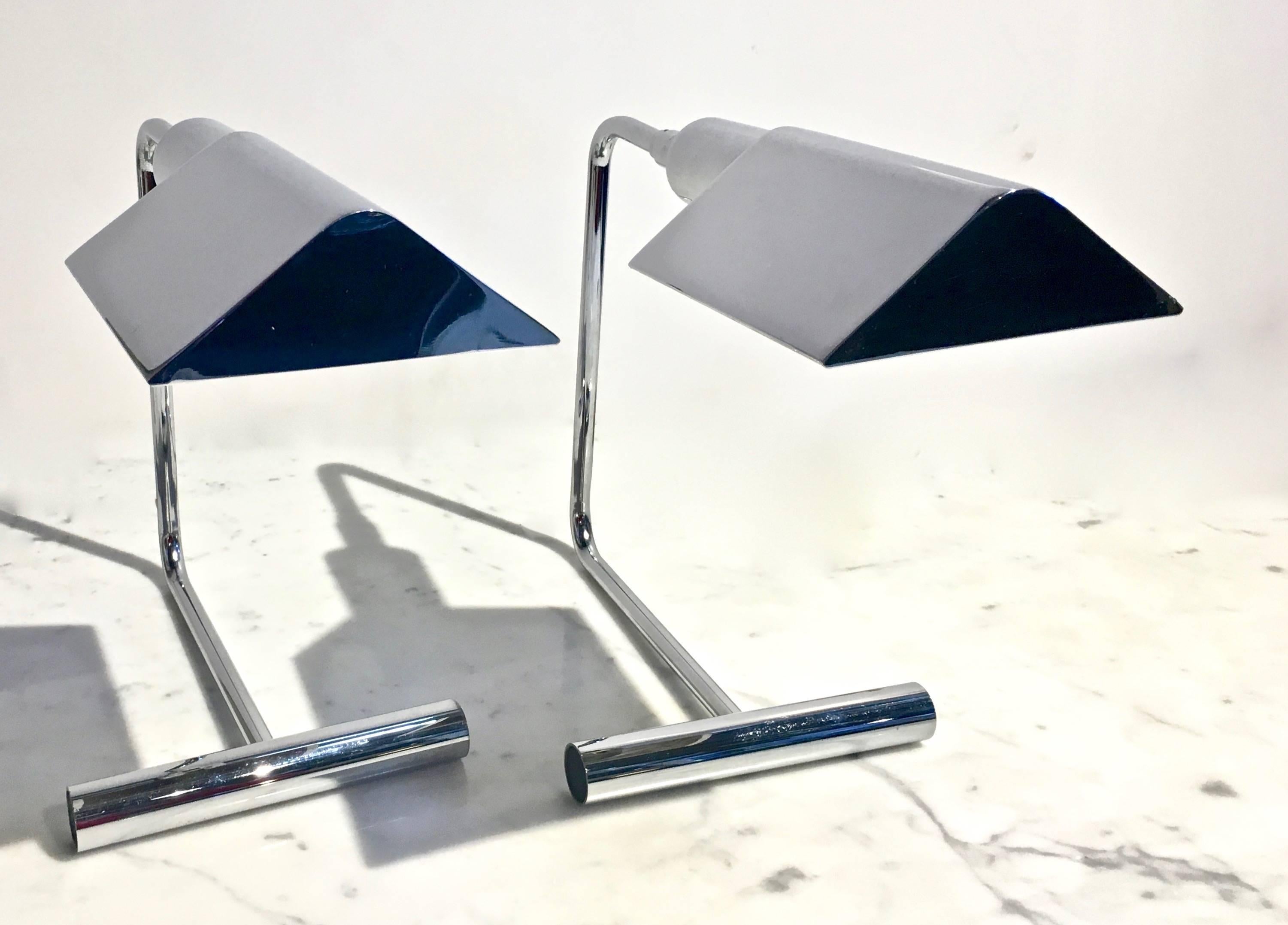 Really clean pair of chrome table lamps stamped by Koch + Lowy table lamps by OMI, circa 1960s-1970s. 
This architectural pair of table lamps are designed with an articulating shade and a dimmer switch for Directional and adjustable lighting. The