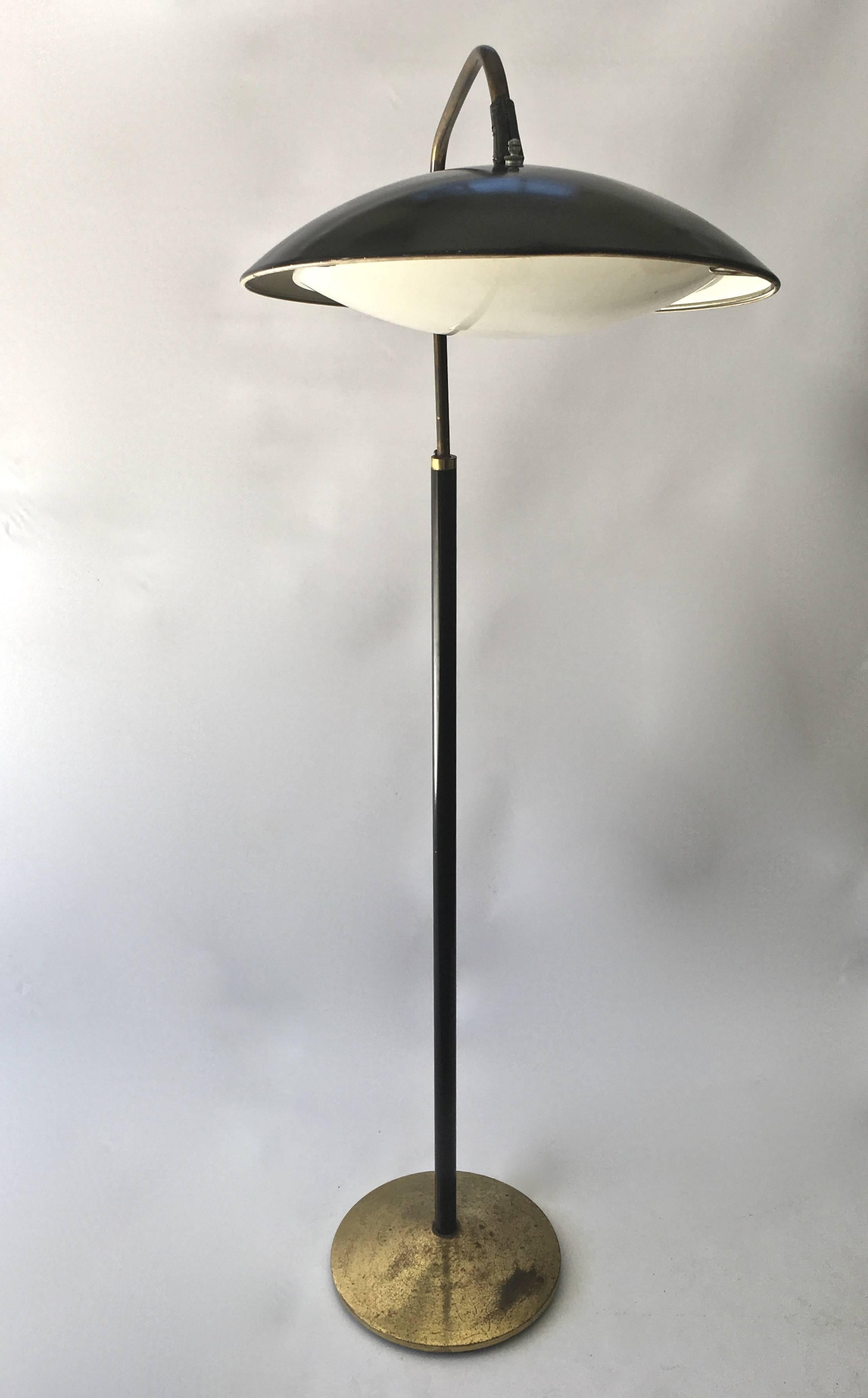 Great lines on this Mid-Century Modern floor lamp designed by Gerald Thurston for Lightolier. Black metal with brass base. Original lense cover over still intact.
Moveable shade can be angled, with three stages of dimming when turned on. 


 