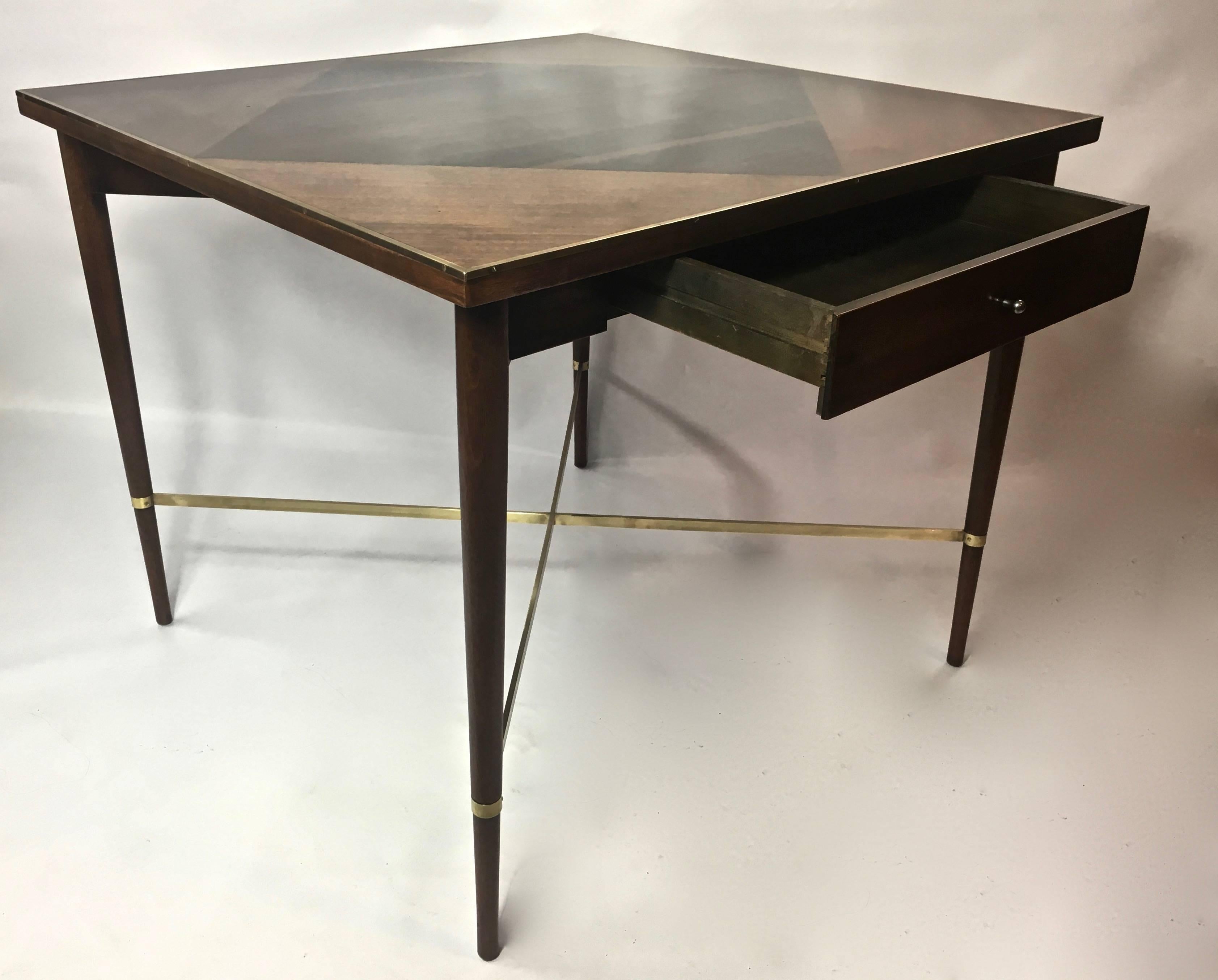 Nearly pristine condition, brought back to original luster, polished and hand finished, with contrasting inlaid zebrawood top. Polished brass X-stretcher, and brass band around the top.
Single drawer with pull. Original metal label still intact in