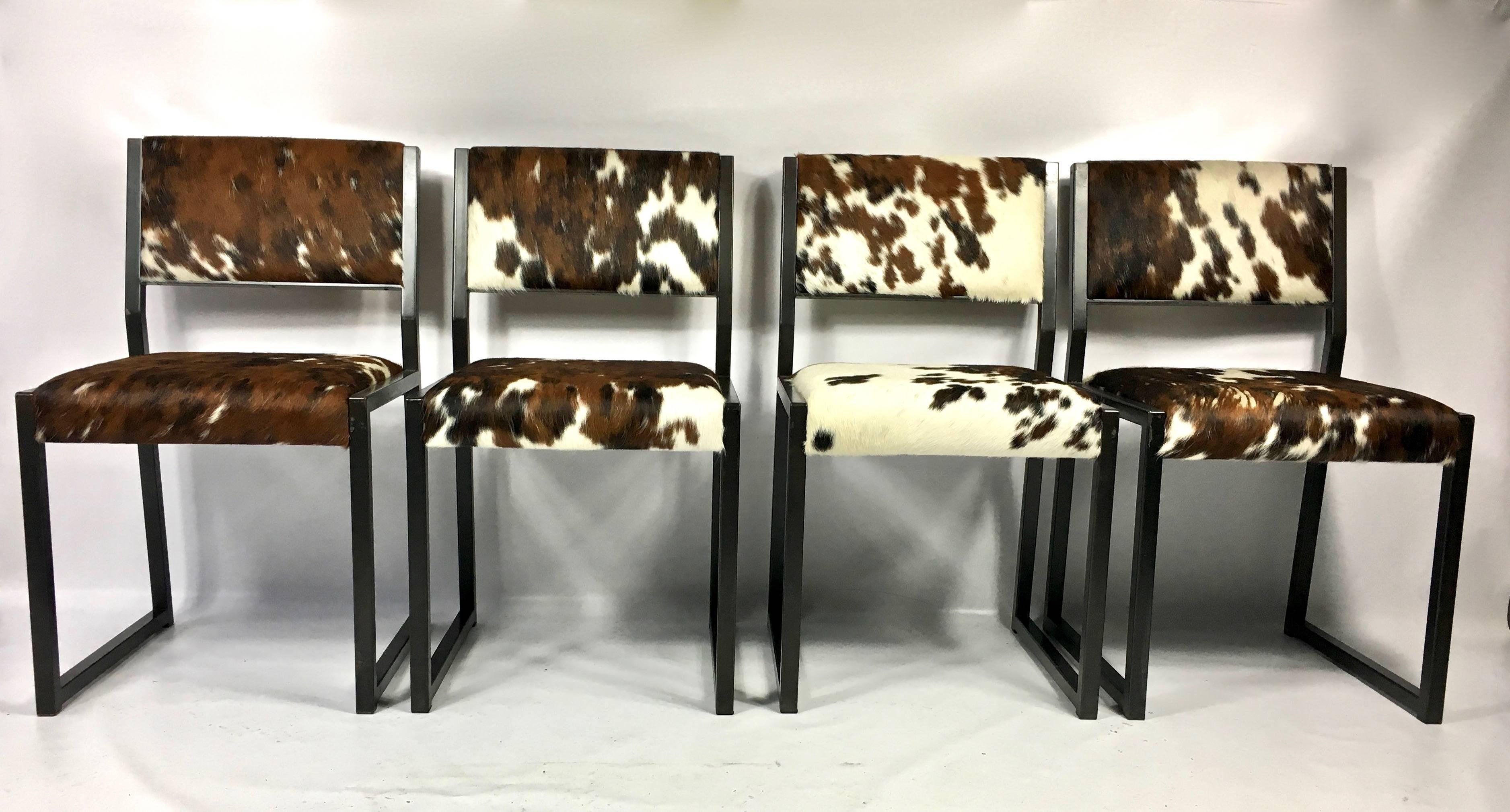 Fantastic set of four custom upholstered pony skin chairs, with hand blackened steel base by Brooklyn base furniture Designer Uhuru.
    