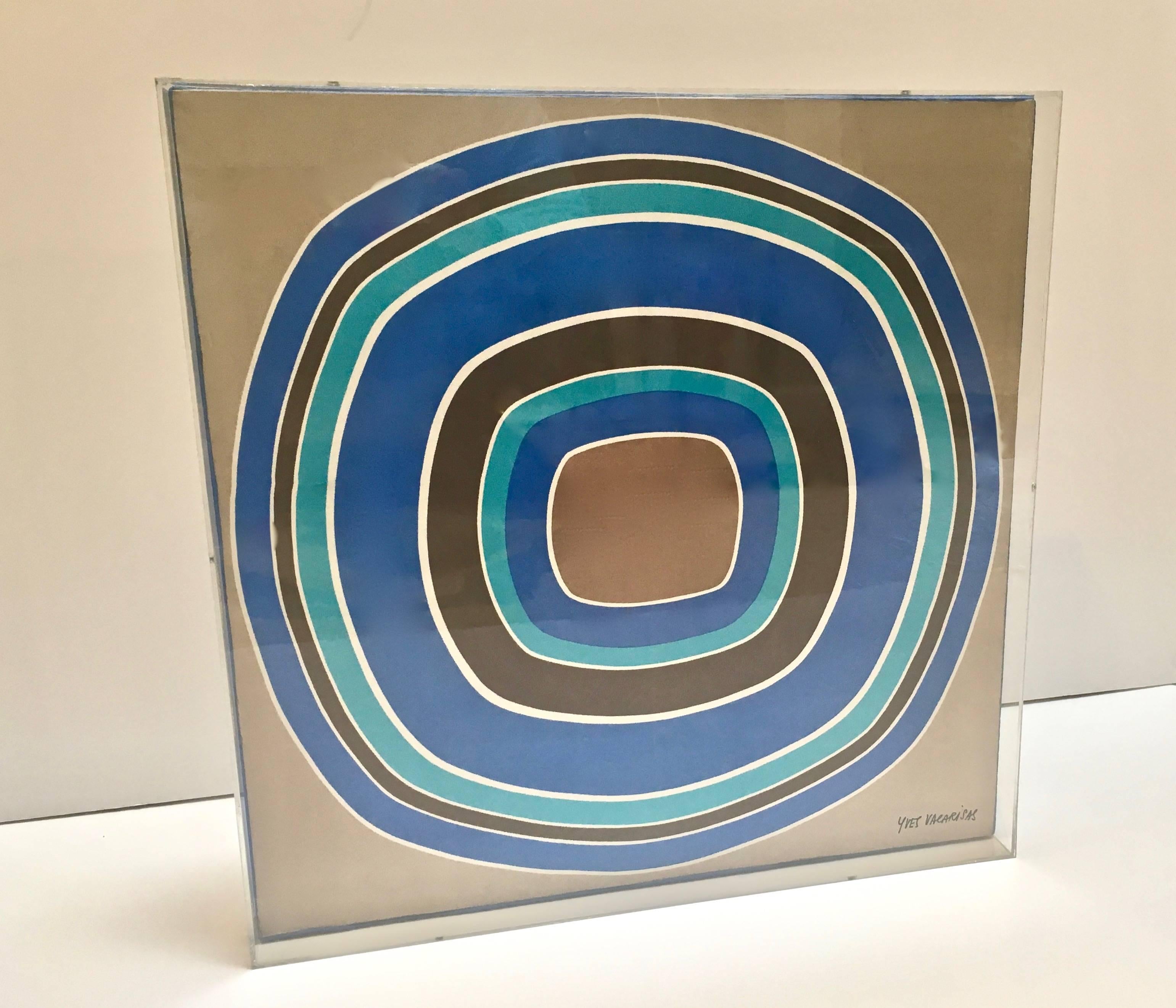Vintage 1970s silk scarf newly framed in custom Lucite box. Artist signature in lower right hand corner, by Yves Vacarisas. A great graphic abstract design of concentric circles, in the manner of Artist Kenneth Noland, in contrasting tones of blues