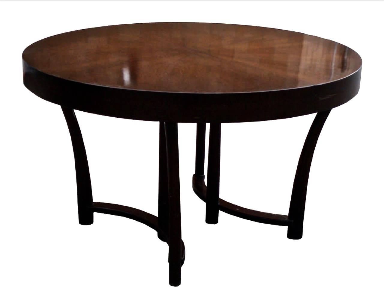 Magnificently refinished walnut dining table with rare starburst veneer top and three extension leaves, by Widdicomb, USA, circa 1950s. This table can be transformed from round to elongated oval by the addition of one, two or three additional