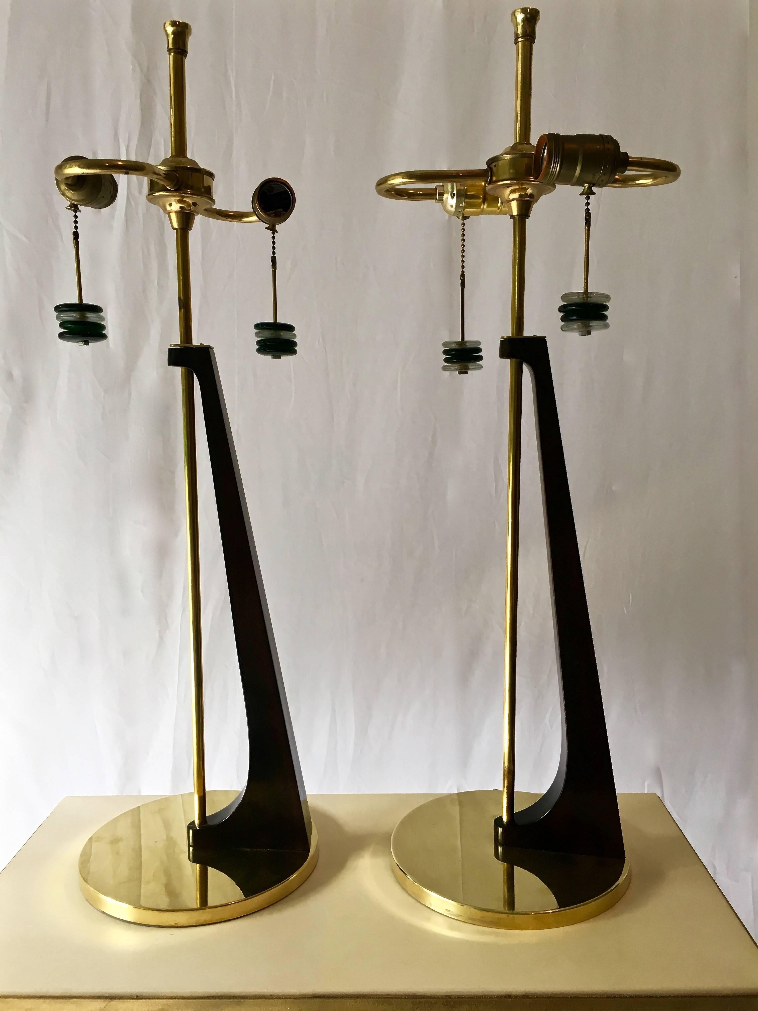Modernist Table Lamps in Architectural Form refinished walnut body in deep chocolate brown stain, and un-lacquered brass bases and rods, newly polished. Ornamental pull chains, decorated with bakelite disks that dangle (and are removable). Original
