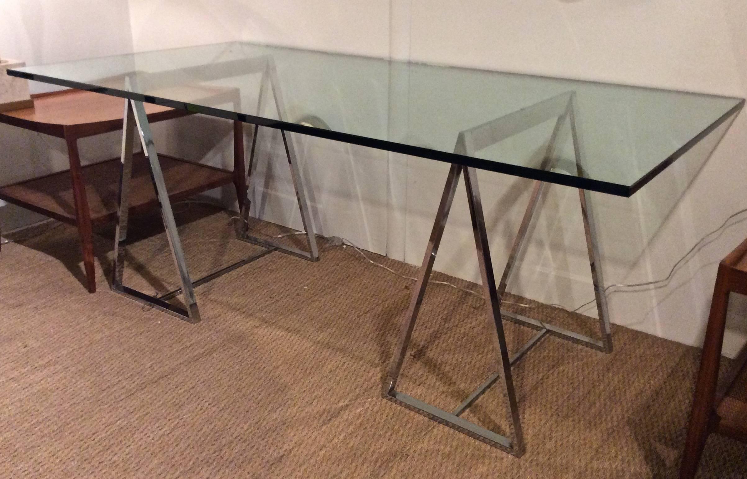 Great pair of 1970s polished chrome sawhorses with free floating thick 3/4 glass top. Versatile size makes it useable for a dining table or desk.

Note: Each chrome base 15 1/4