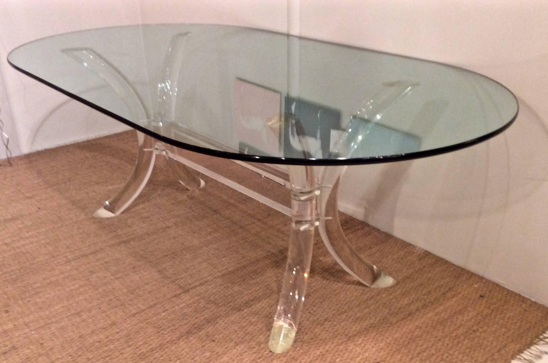 Gorgeous curved lucite saber legs, and faceted center lucite block, form the elegant base of this table, designed By Charles Hollis Jones. Vintage Lucite is clear, and oval green edged glass is a substantial 5/8 thick.  Some scratches commensurate