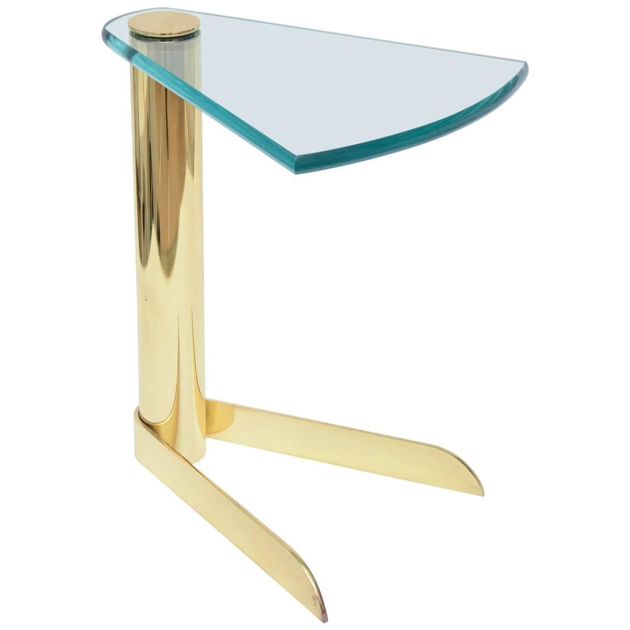 Hard to find pair of sculptural wedge shaped cigarette or drinks table has wonderful form and substance. The polished green edged glass is 1/2 inch thick, and cantilevers over the columned body and pie-shaped patinated brass base.
Can be polished