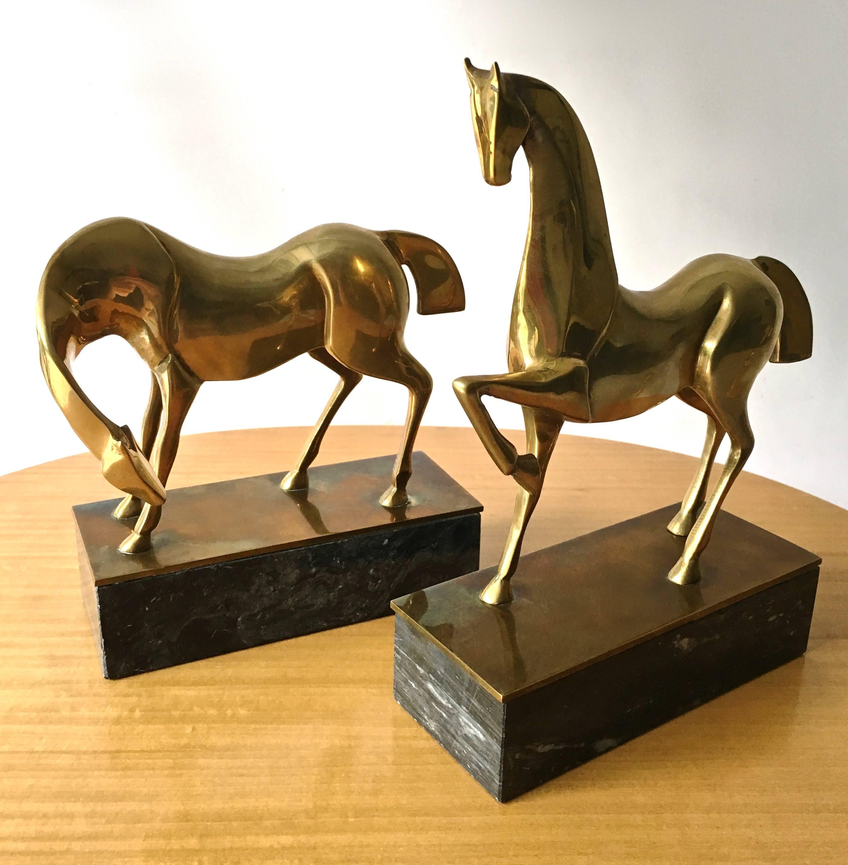 A majestic pair of Etruscan horse in brass finish with oxidized highlights, on marble bases in Manner of renown sculptors Boris Lovet-Lorski and Elie Nadelman.

Each base measures 6
