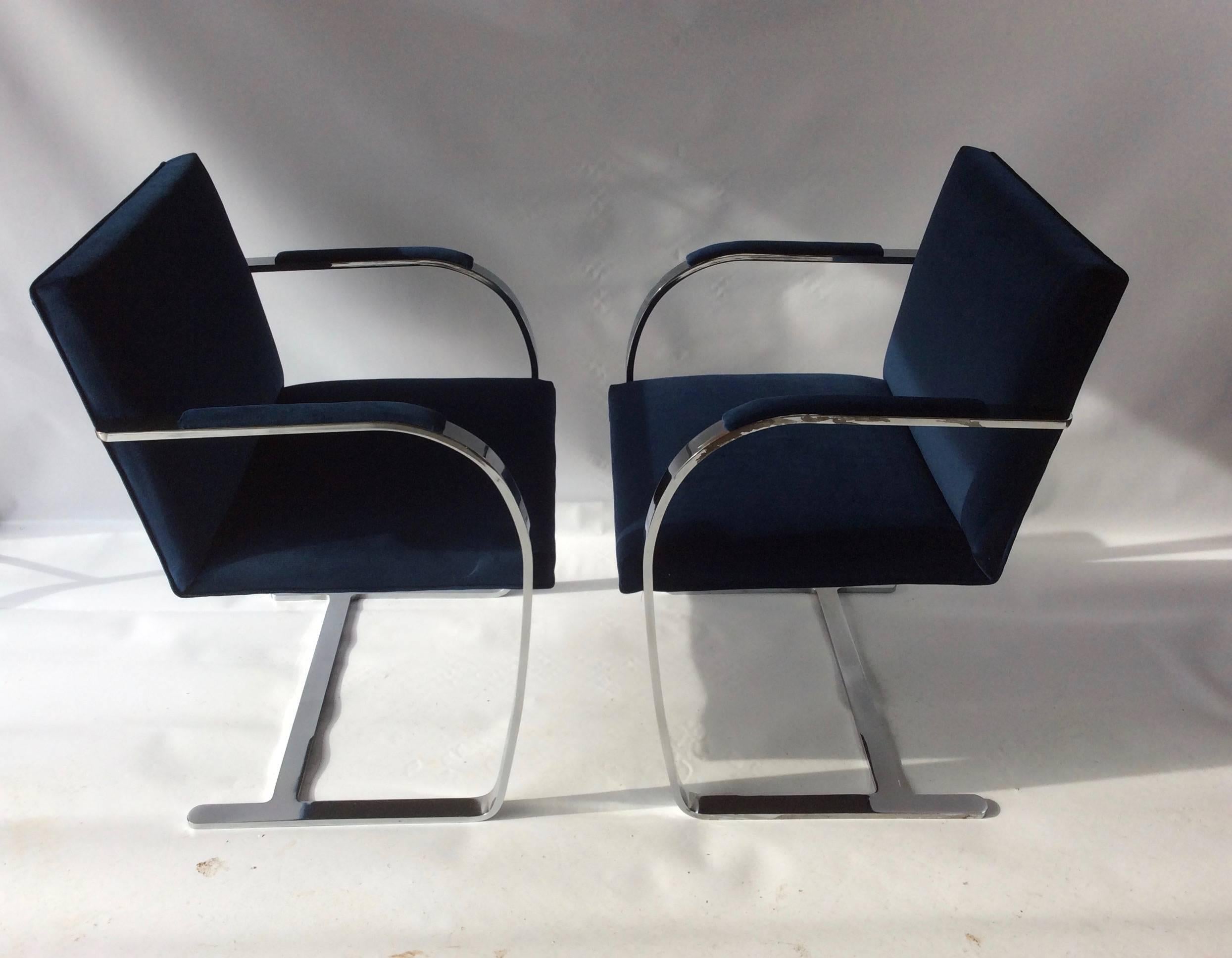 A striking pair unmarked BRNO cantilevered chairs, attributed to Mies Van Der Rohe. Chrome finish on clean lined, flat bar frames. Newly re-upholstered in a gorgeous prussian or navy blue fabric by Pindler and Pindler.
