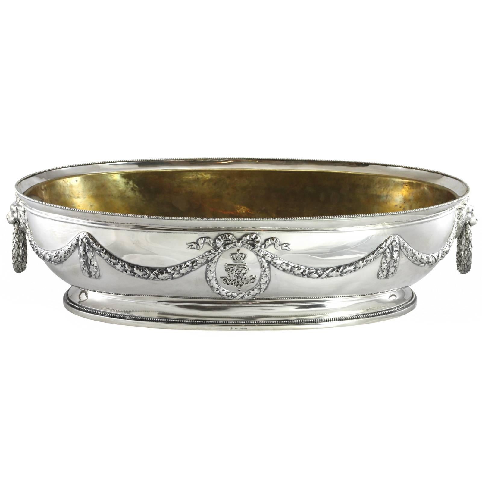 A .800 continental silver oval shaped presentation champagne bucket by J. D. Schleissner Söhne of Hanau, Germany. The piece features a removable copper liner, which has been foil gilded. One side of the bucket displays a crowned monogram, with an