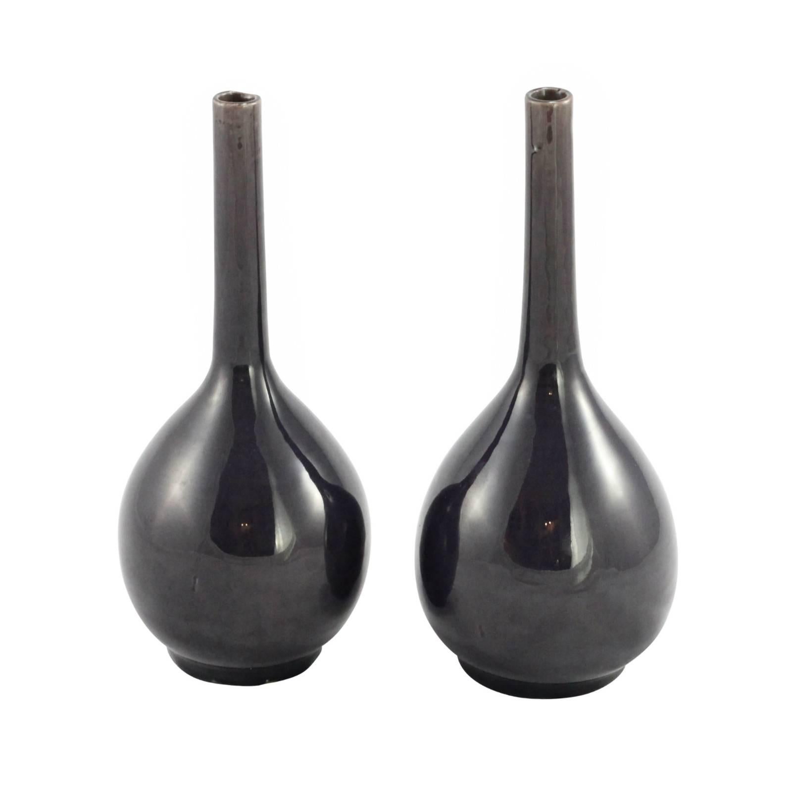 A pair of 18th century Chinese Qing dynasty aubergine monochrome glazed bottle vases, produced during the Qianlong period.

Provenance: Sotheby's Australia November 2002 Auction Lot 555, from the estate of Ross Gordon.