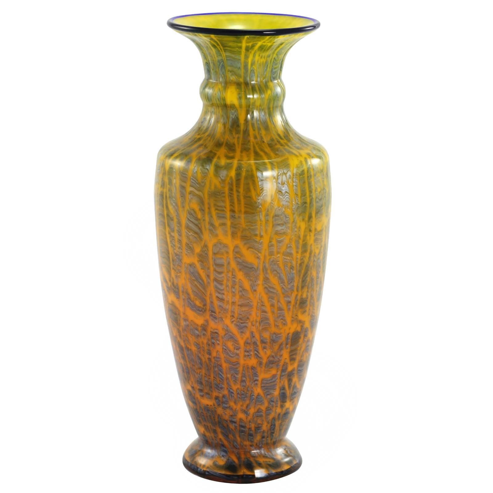 An early 20th century Bohemian art deco glass vase by famed European glassmakers, Loetz. Completed with a subtle orange to yellow ground, and cobalt blue rim; the vase is decorated with an overlaid steel grey crackle layer from the 'Ausfuehrung 134'