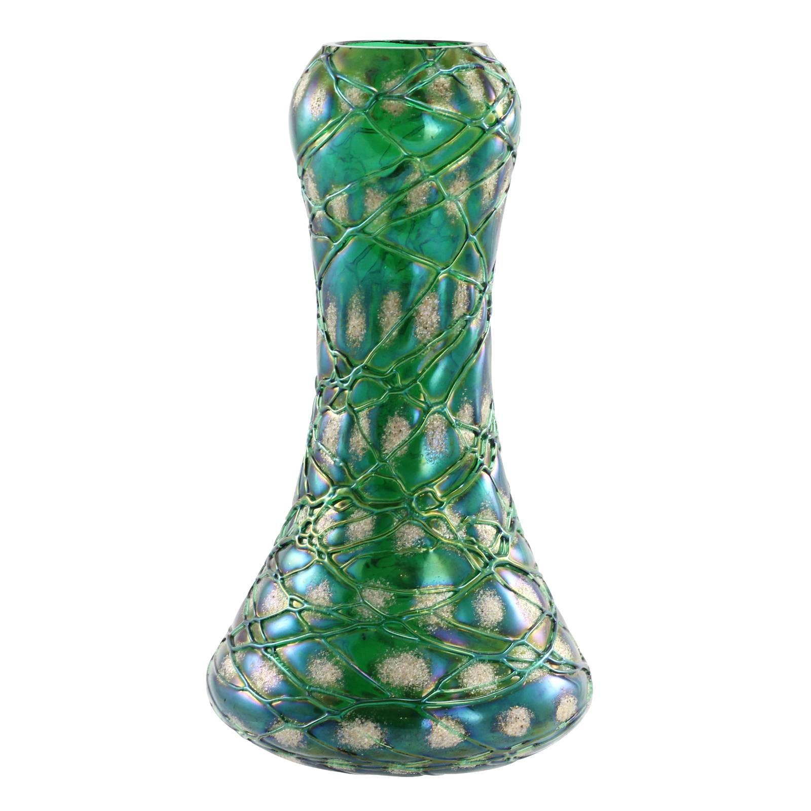 A turn of the century Bohemian Art Nouveau glass vase in the 'Snowflake' decor by Kralik. With an iridescent dark green ground, and fine crisscrossed threading, this vase has been completed with the addition of white frit 'snowflakes.'